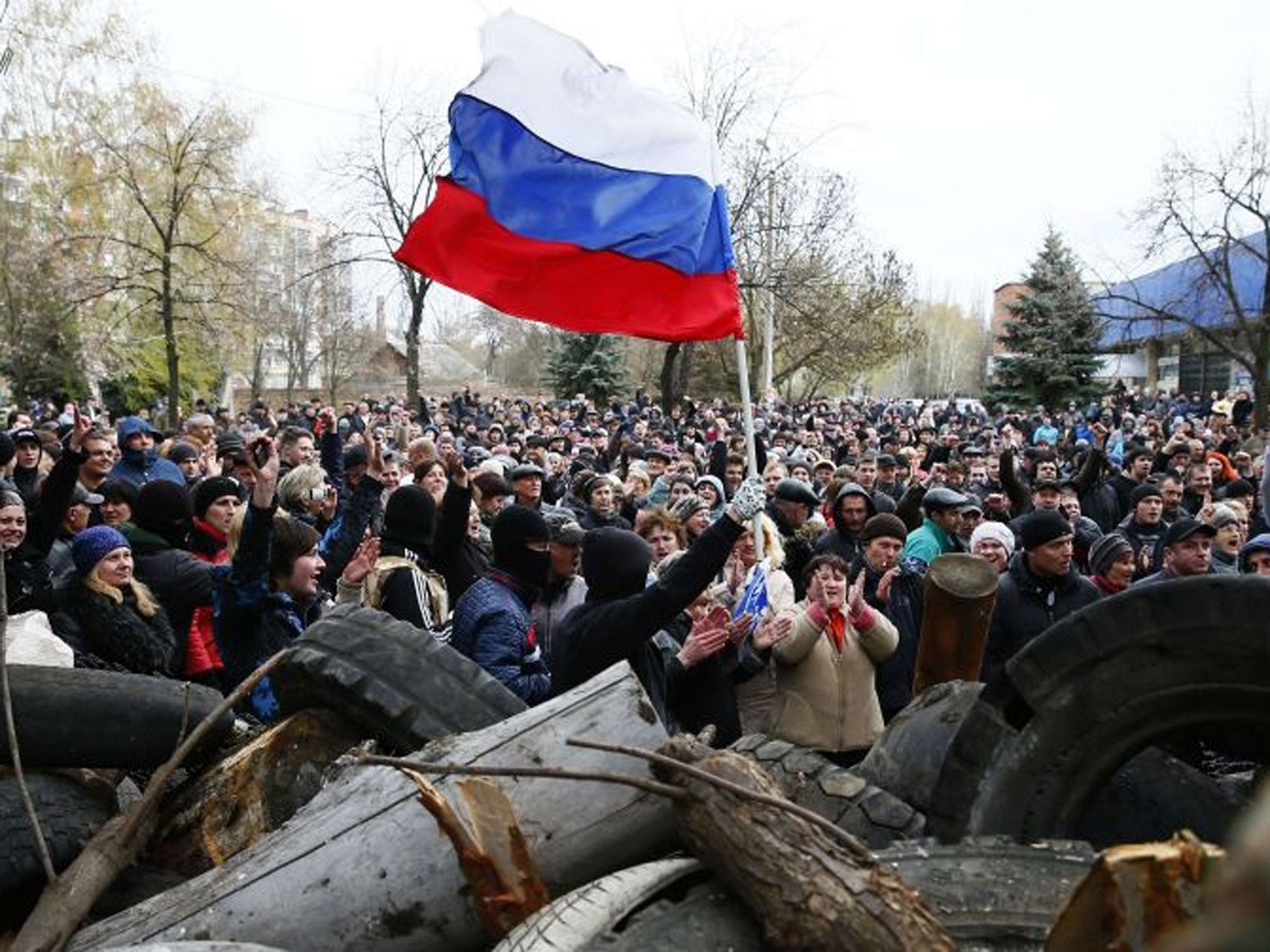 Pro-Russian protestors wave the Russian flag in front of the police headquarters in Slaviansk