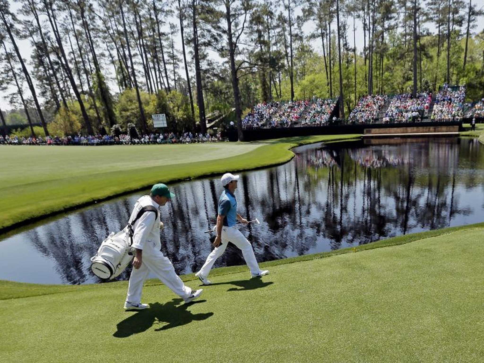 Rory McIlroy strides out during the third round of the Masters yesterday