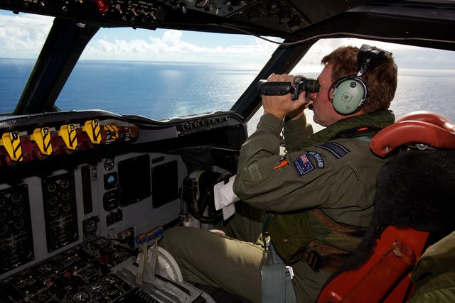 Royal New Zealand Air Force personnel  take part in the search to locate the missing Malaysia Airways Flight MH370 over the Indian Ocean