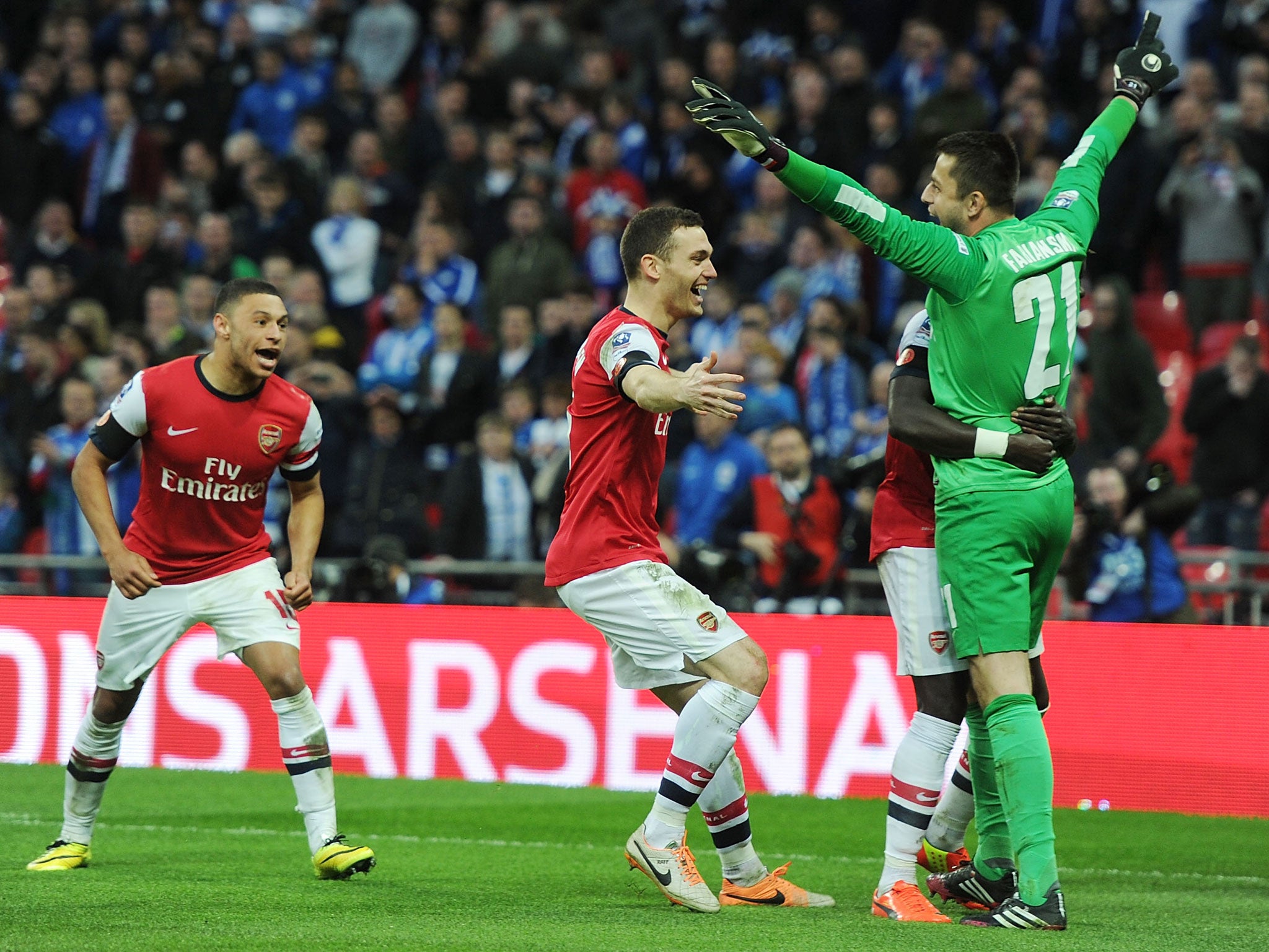 Thomas Vermaelen (third from right) celebrates with penalty-saving goalkeeper Lukasz Fabianski after Arsenal defeat Wigan in the FA Cup semi-final