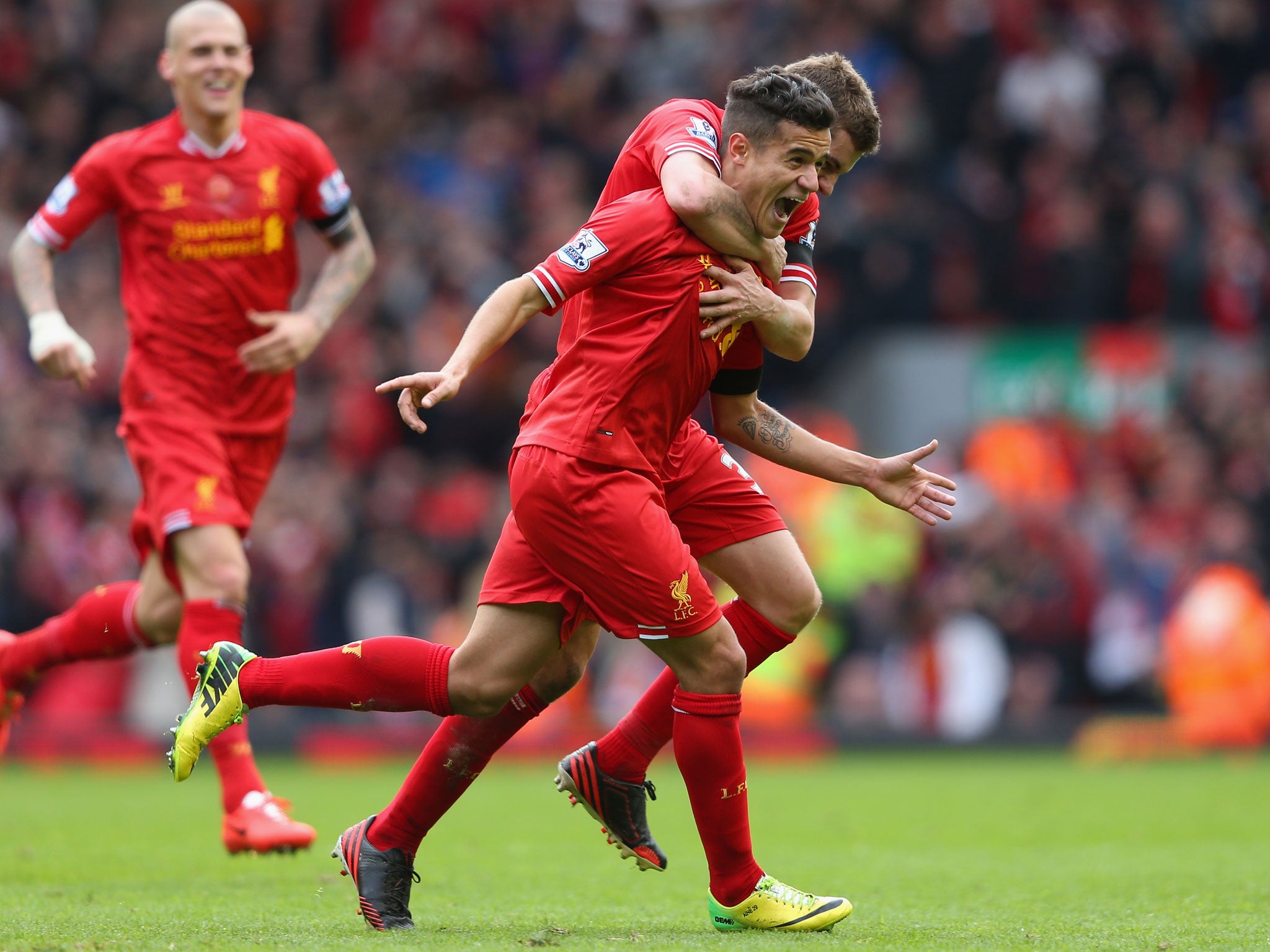 Philippe Coutinho celebrates his wining strike for Liverpool with Steven Gerrard