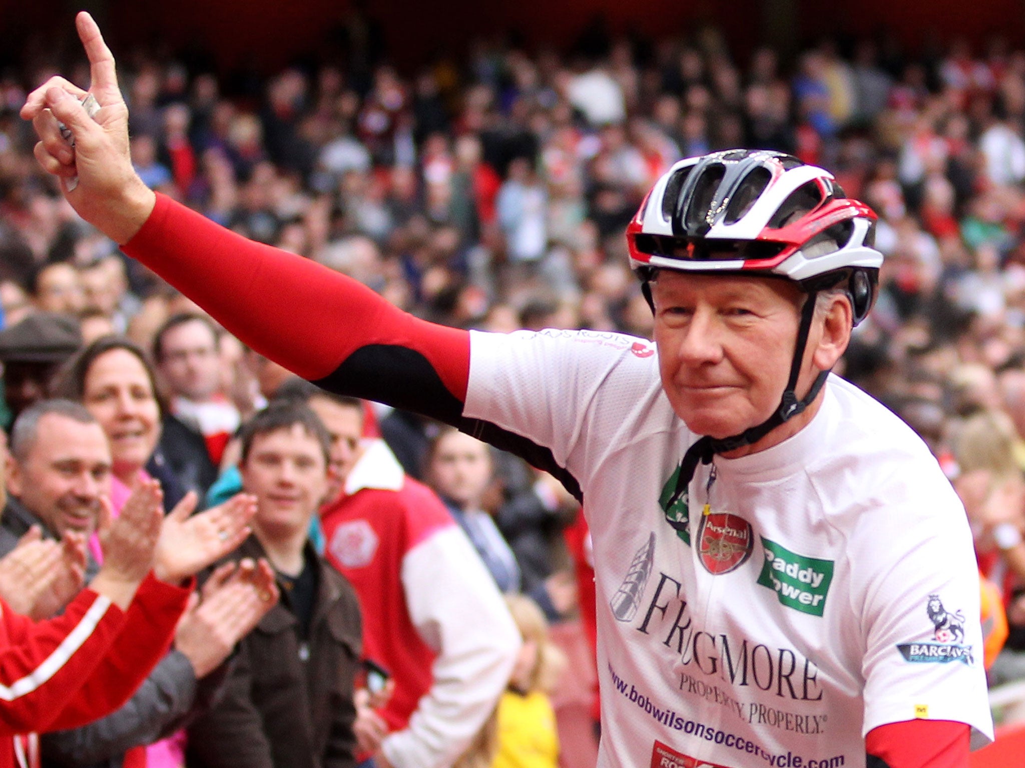 Former Arsenal goalkeeper Bob Wilson cycles around the Emirates Stadium to launch his 500 mile cycling challenge in April 2011