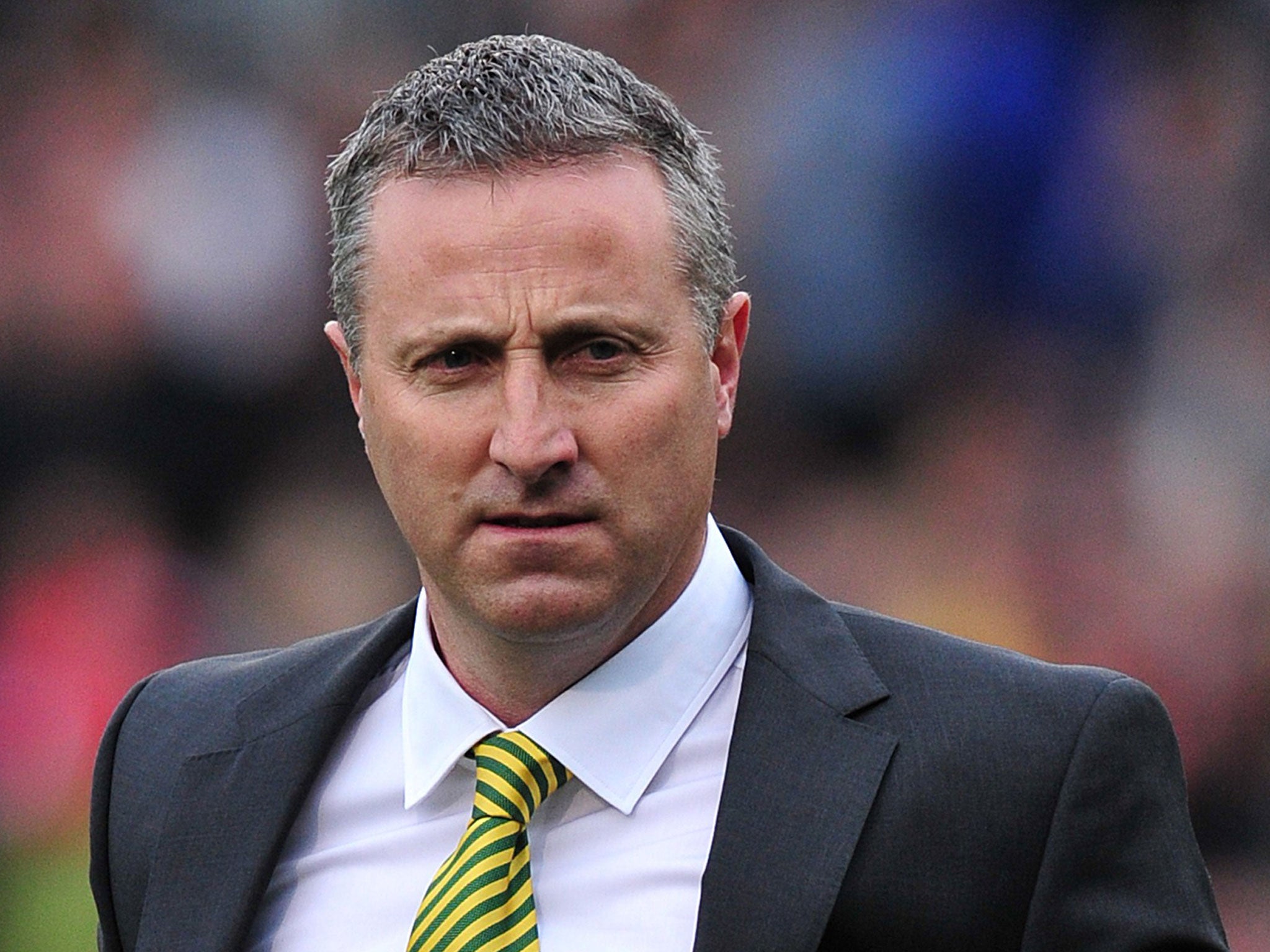 Norwich City manager Neil Adams looks on at Craven Cottage