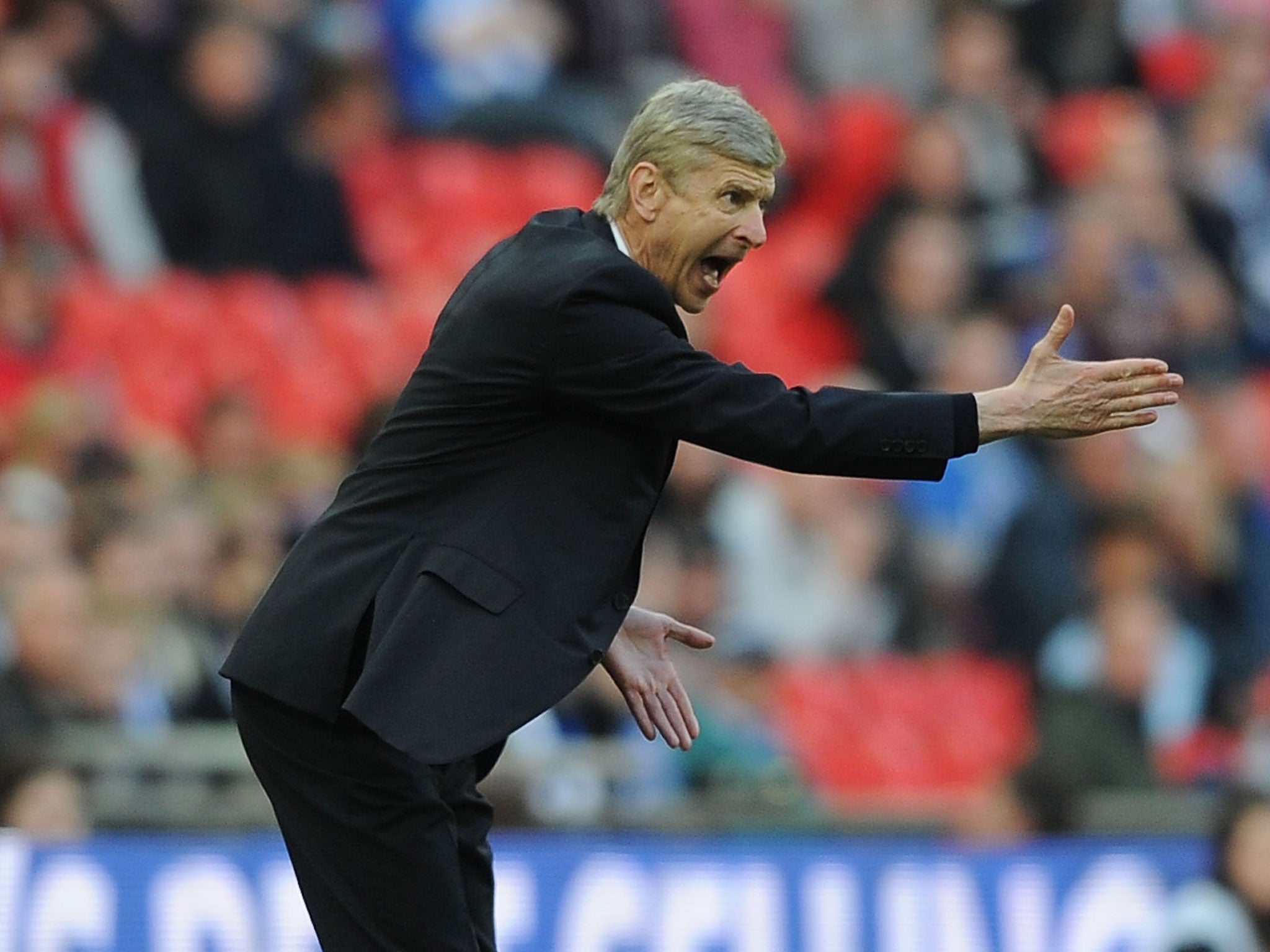 Arsene Wenger makes a gesture from the touchline at Wembley on Saturday