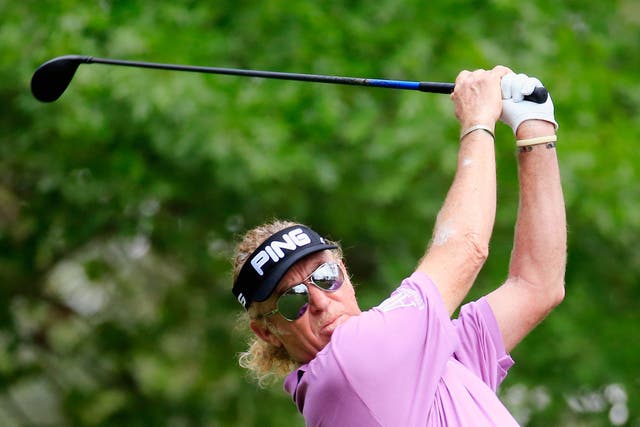 Miguel Angel Jimenez of Spain watches his tee shot on the fourth hole