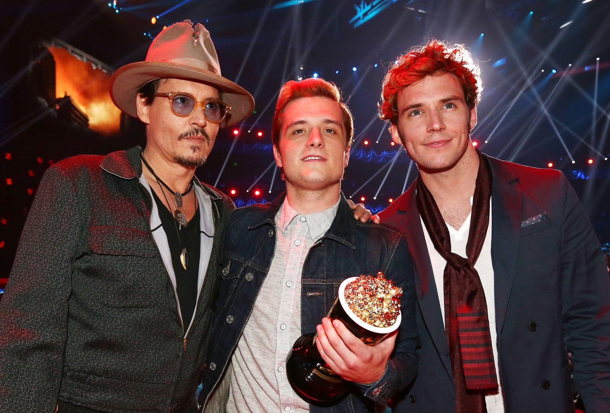 Johnny Depp (left) awards Josh Hutcherson for Best Male Performance for his role in the Hunger Games