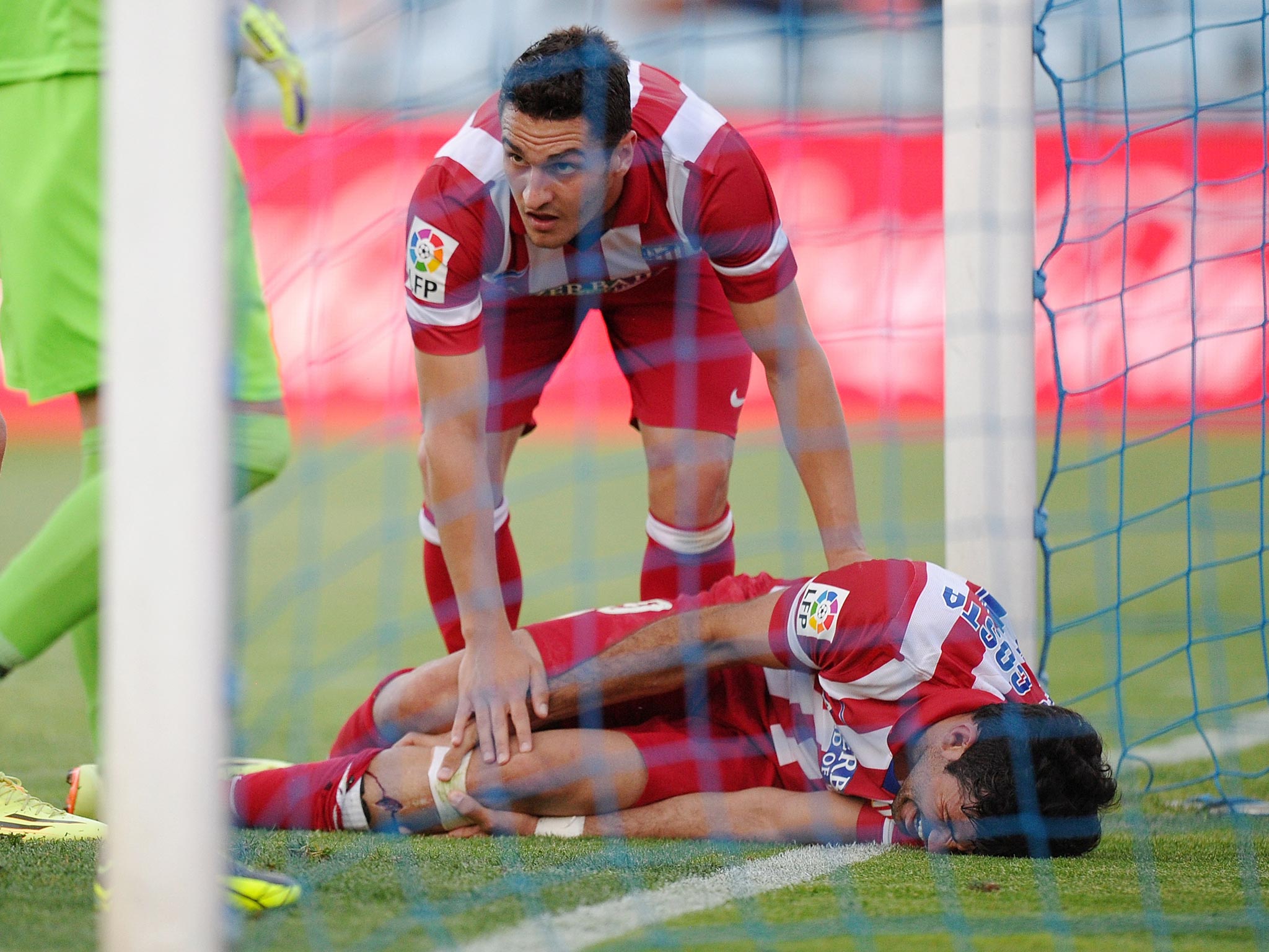Diego Costa lies in pain after hitting the post when scoring in Atletico Madrid's 2-0 win over Getafe