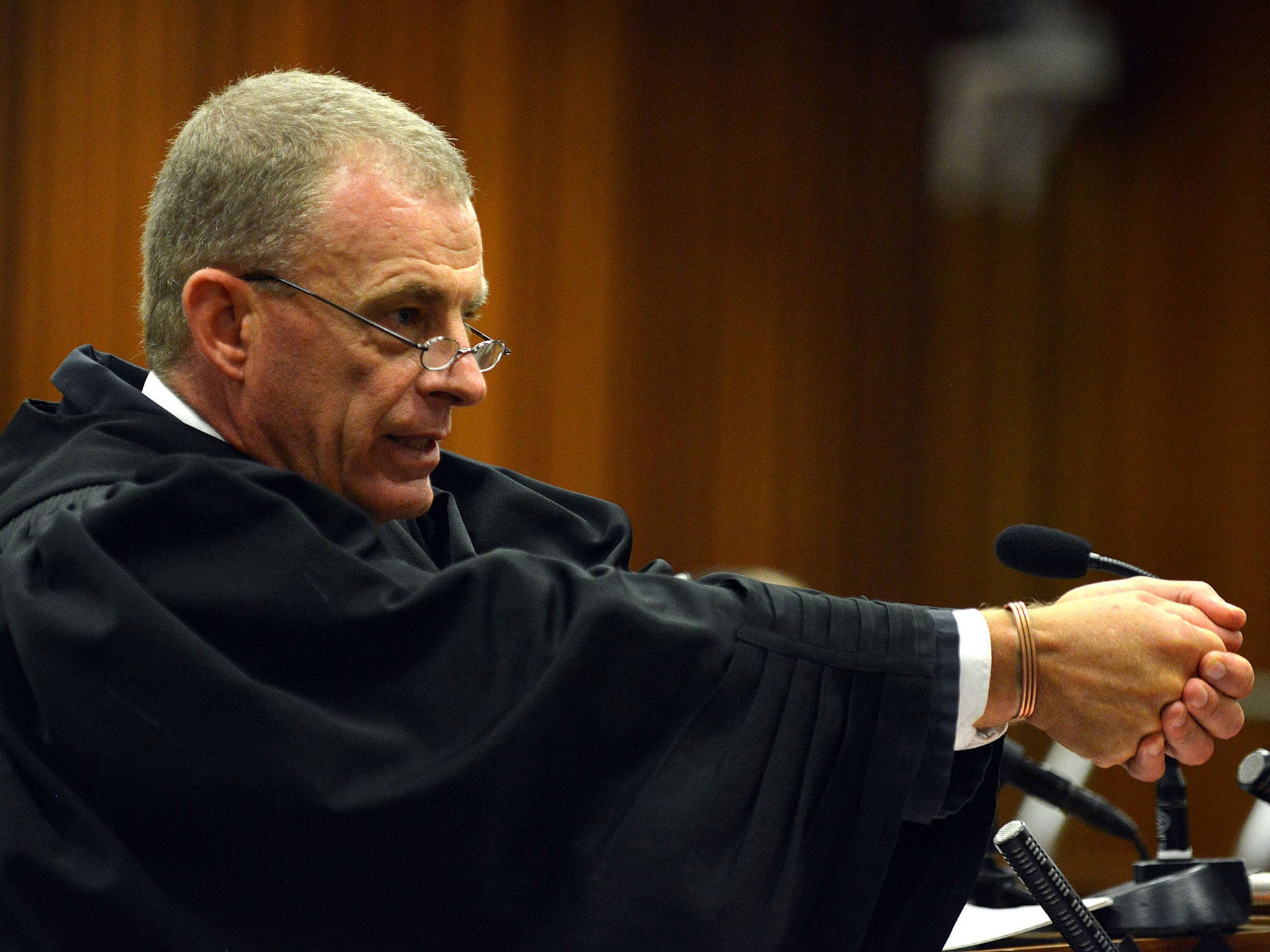 Prosecutor Gerrie Nel gestures as he explains a possible scenario into how Oscar Pistorius might have fired on girlfriend Reeva Steenkamp in court in Pretoria