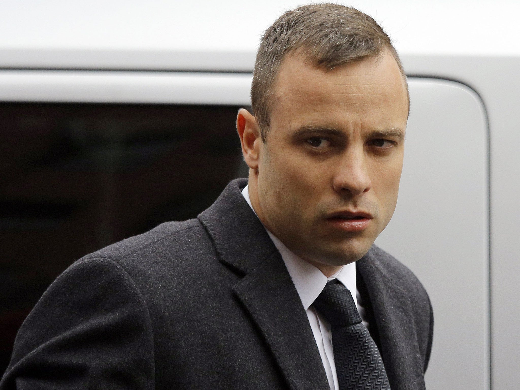 Oscar Pistorius arrives at court prior to another day of cross examination during his ongoing murder trial in Pretoria