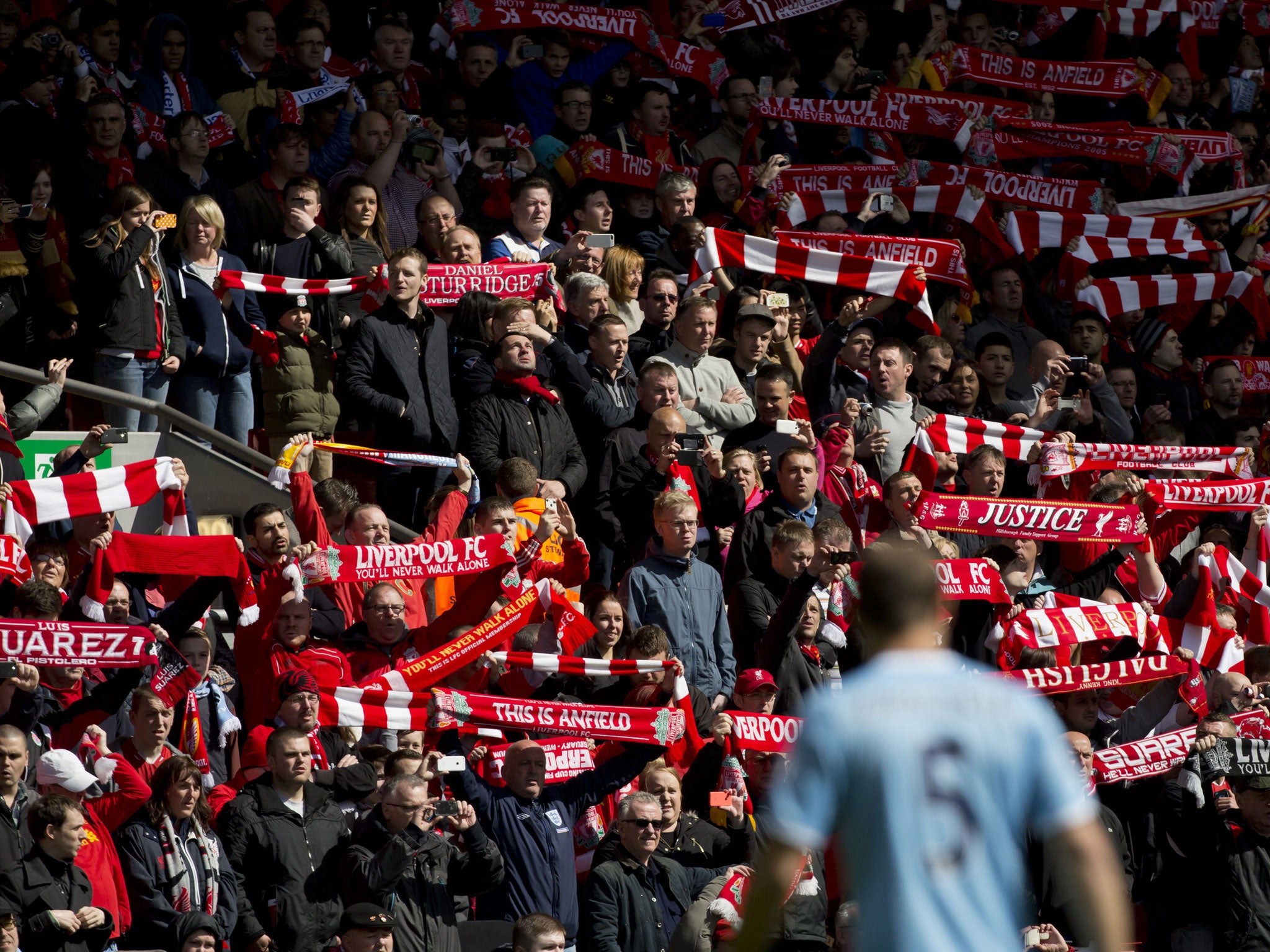 Before their English Premier League soccer match at Anfield Stadium against Manchester City Liverpool supporters hold their scarves prior to a minute's silence in tribute to the 96 supporters who lost their lives in the Hillsborough disaster of 25 years a