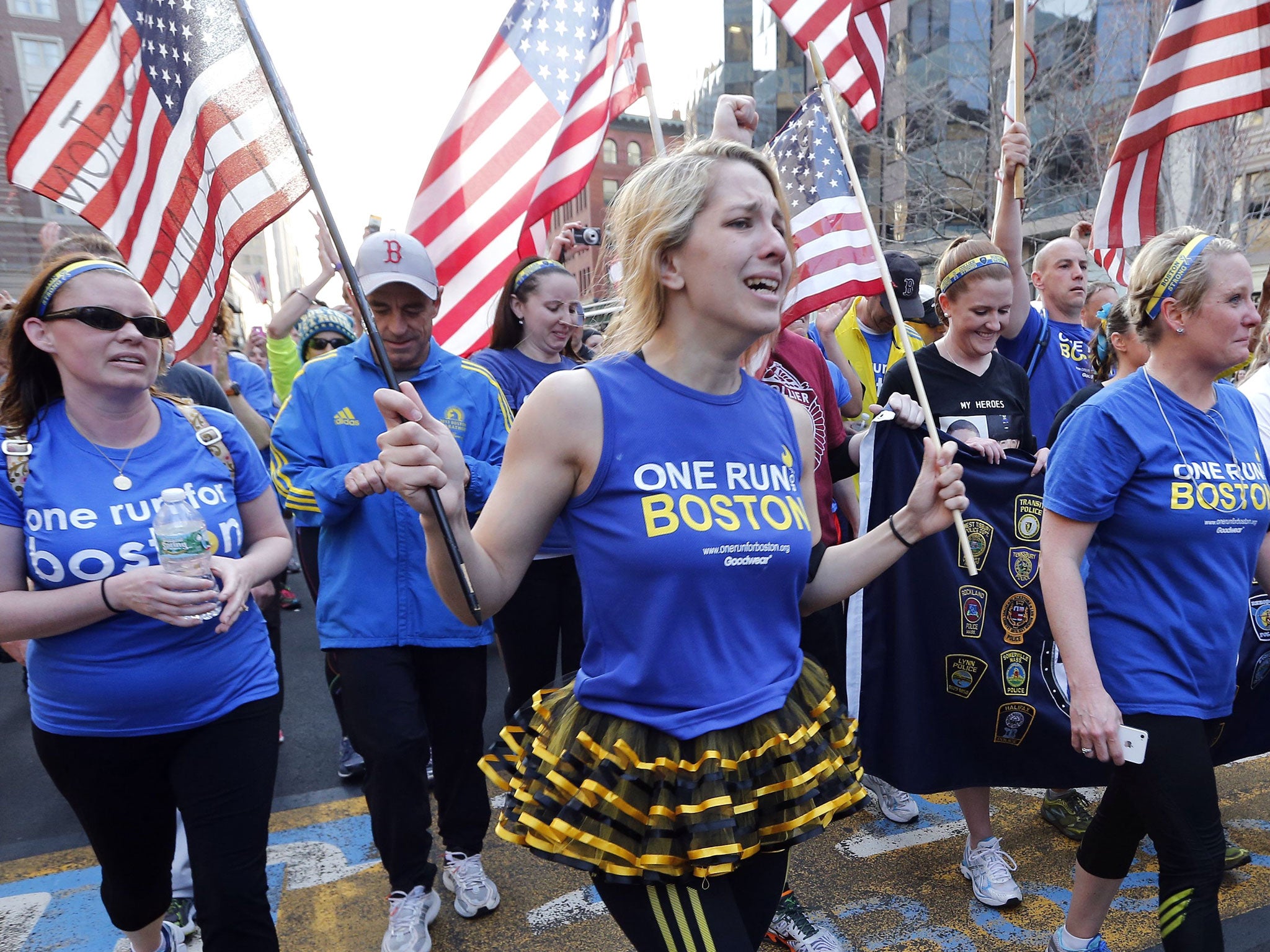 Boston Marathon bombing survivors, family members and supporters joined the relay runners for the final half-block to the finish