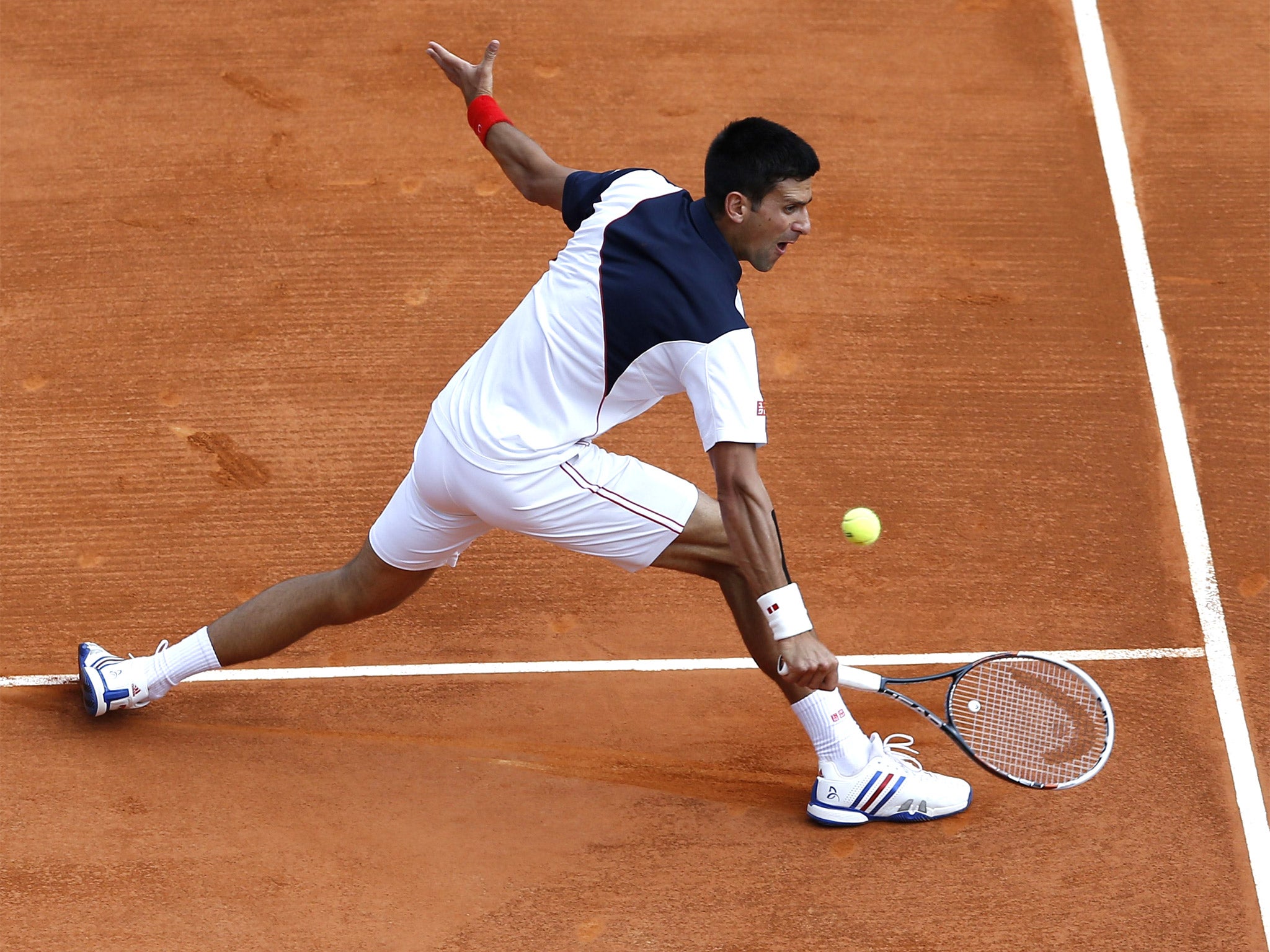 Novak Djokovic hits a return during his victory against Albert Montanes