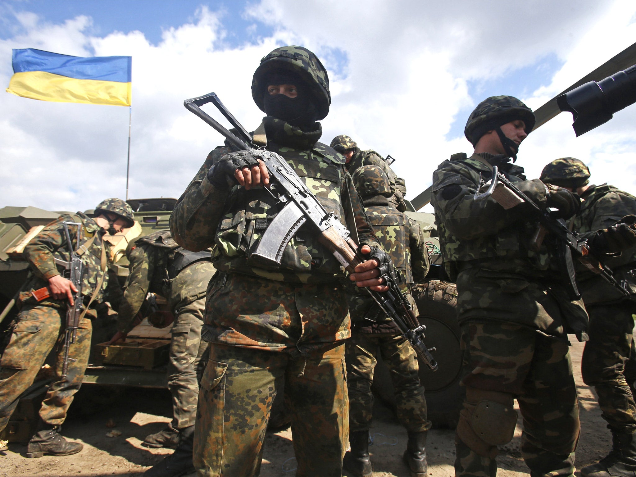 Ukrainian army troops receive ammunition in a field on the outskirts of Izyum in eastern Ukraine