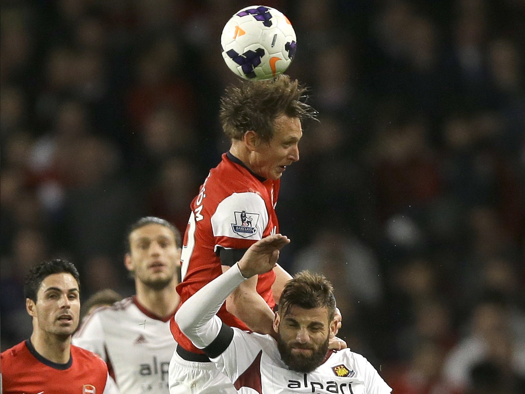 Kim Kallstrom leaps for the ball last night, when he made an encouraging start for Arsenal after a long injury lay-off