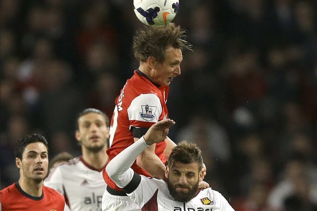 Kim Kallstrom leaps for the ball last night, when he made an encouraging start for Arsenal after a long injury lay-off