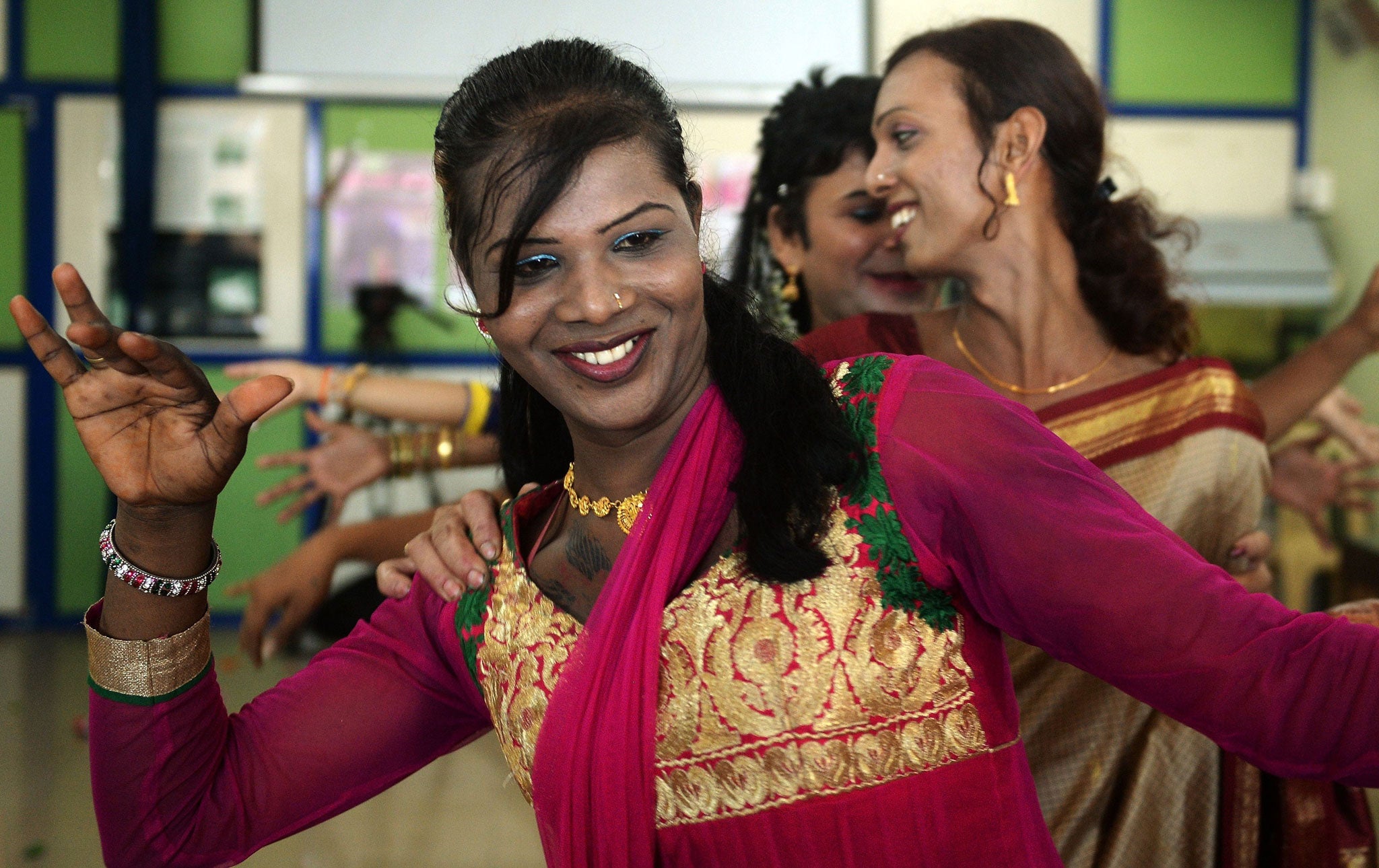 An Indian transgender person dances with others at an event to celebrate a Supreme Court judgement in Mumbai on 15 April, 2014