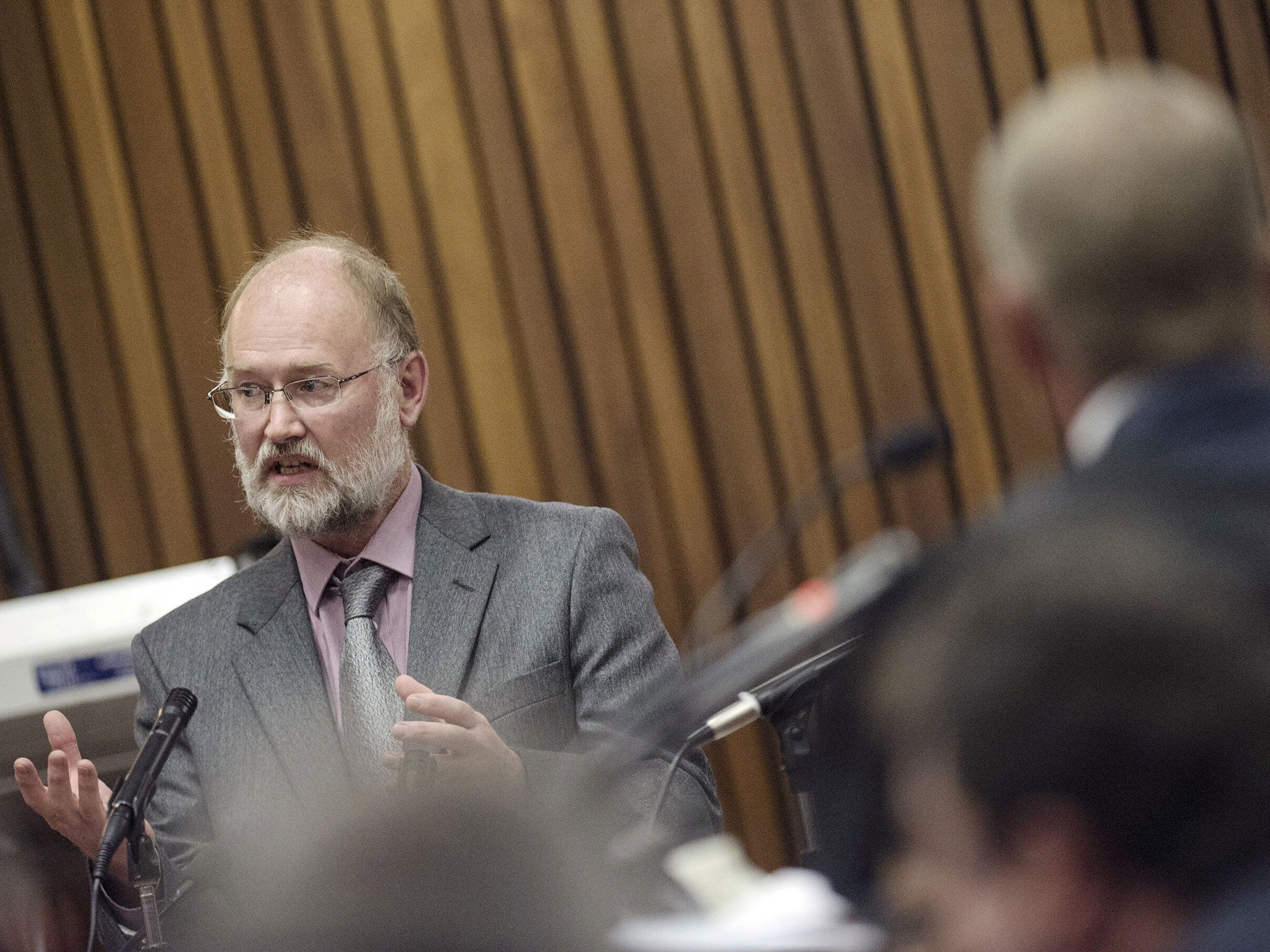 Forensic Expert Roger Dixon (L) answers to questions from State Prosecutor during the Oscar Pistorius trial at the North Gauteng High Court on April 16, 2014