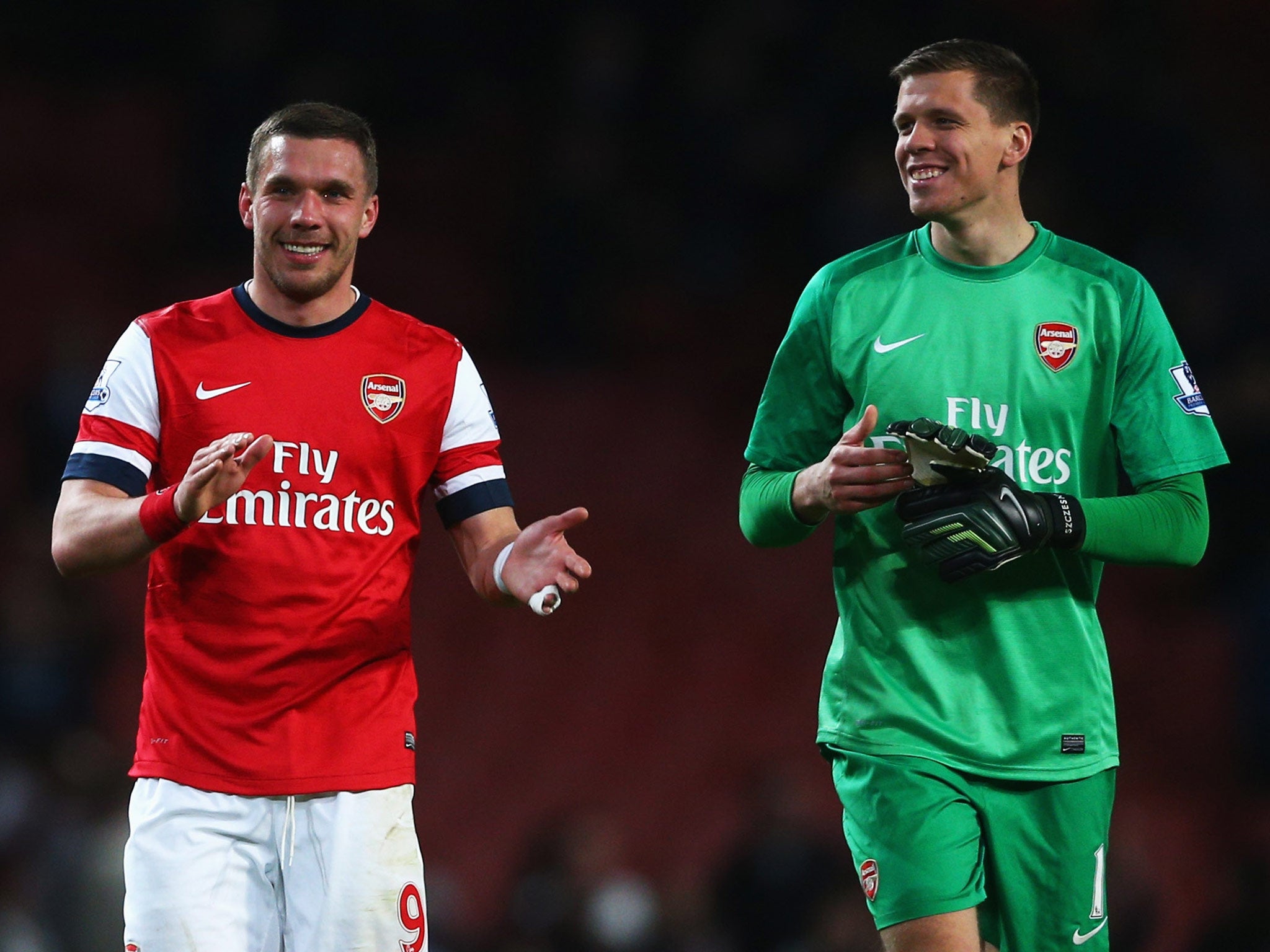 Lukas Podolski (left)and Wojciech Szczesny of Arsenal celebrate victory over West Ham
