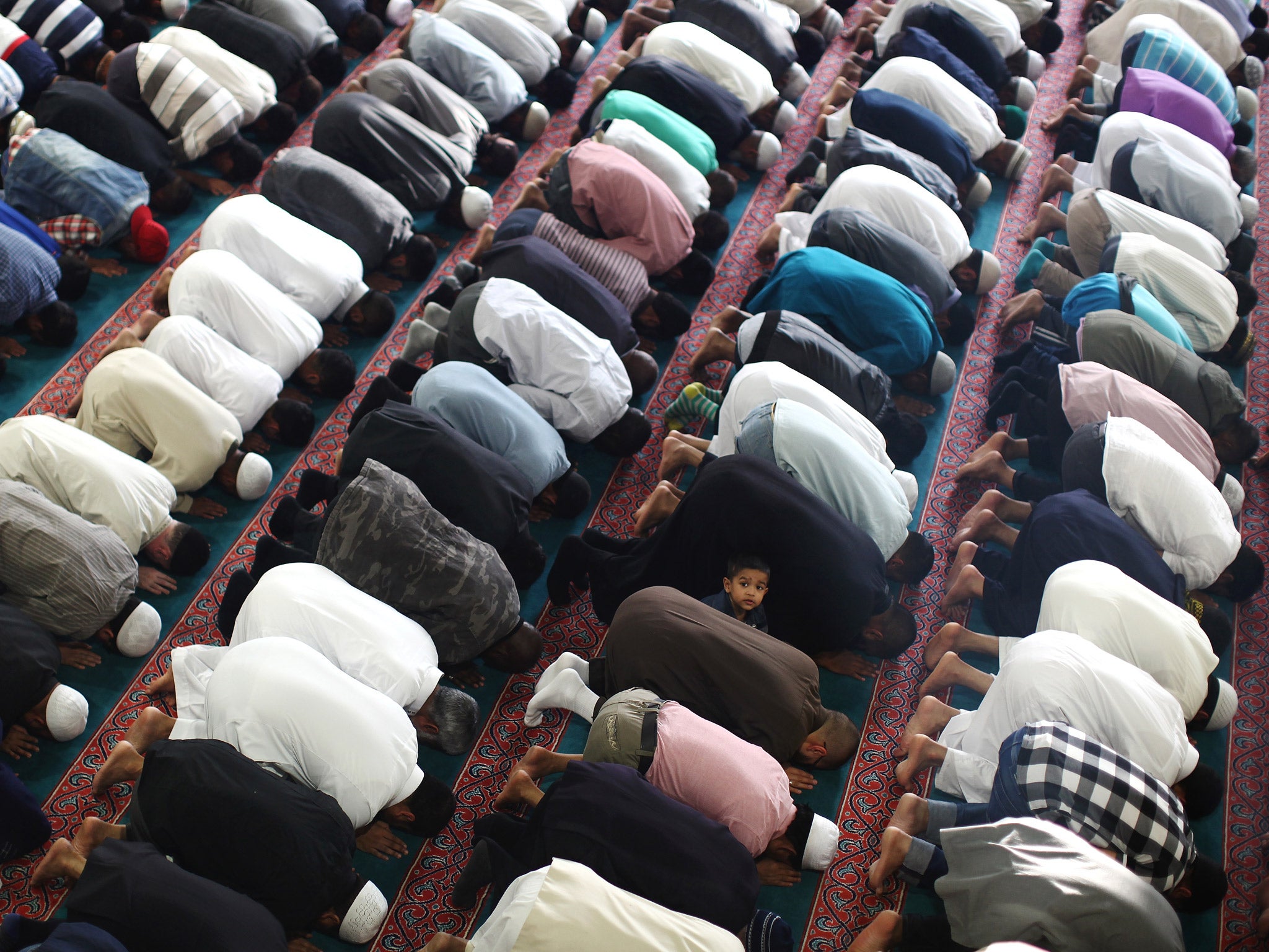 Muslim men pray at the East London Mosque