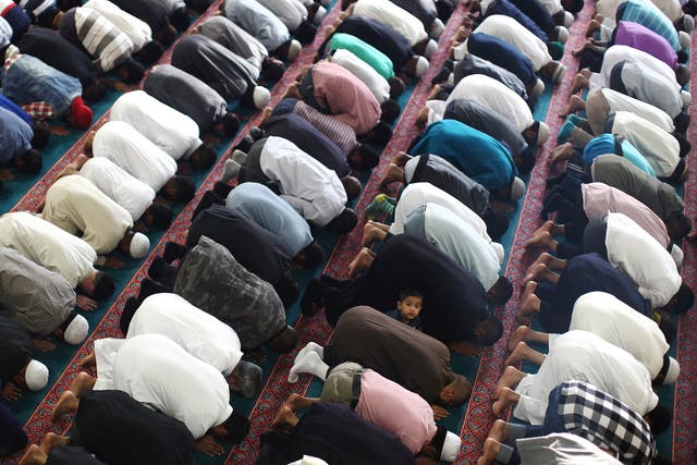 Muslim men pray at the East London Mosque