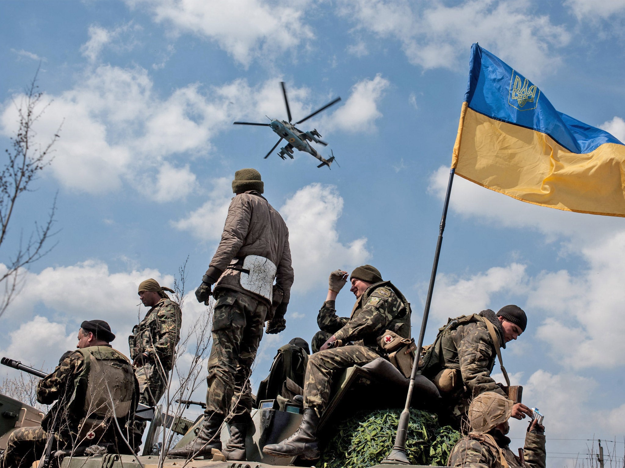 Ukrainian soldiers fly the flag on top of their armoured vehicle in Kramatorsk