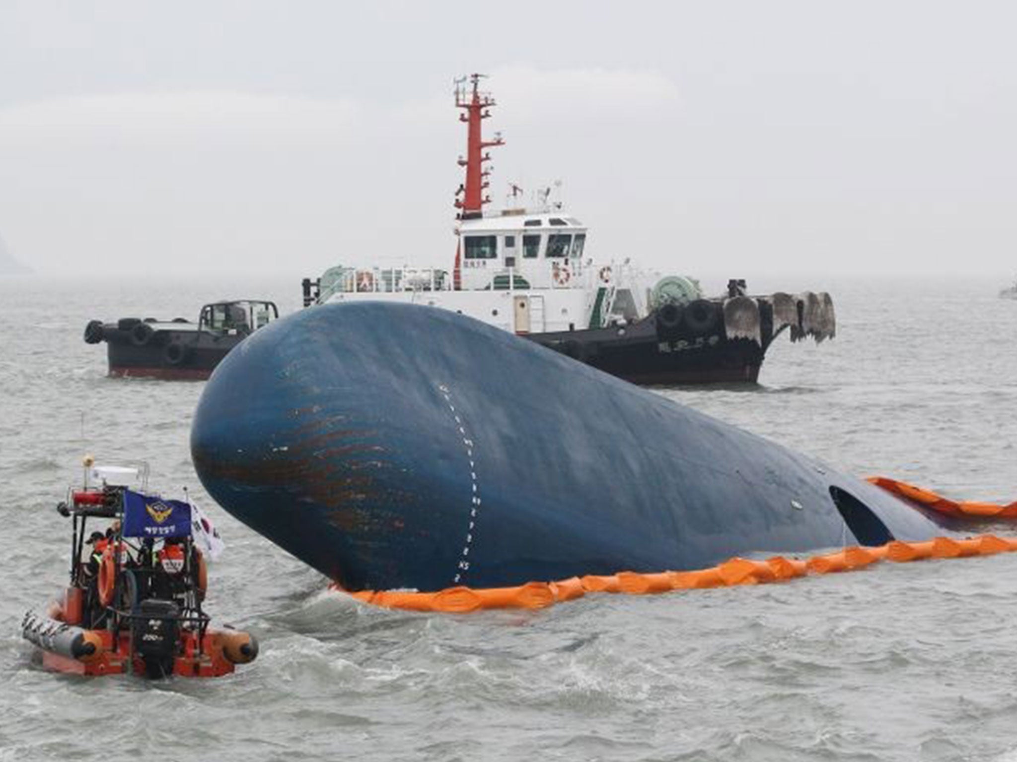 South Korean Coast Guard officers search for missing passengers aboard a sunken ferry in the water off the southern coast near Jindo, South Korea