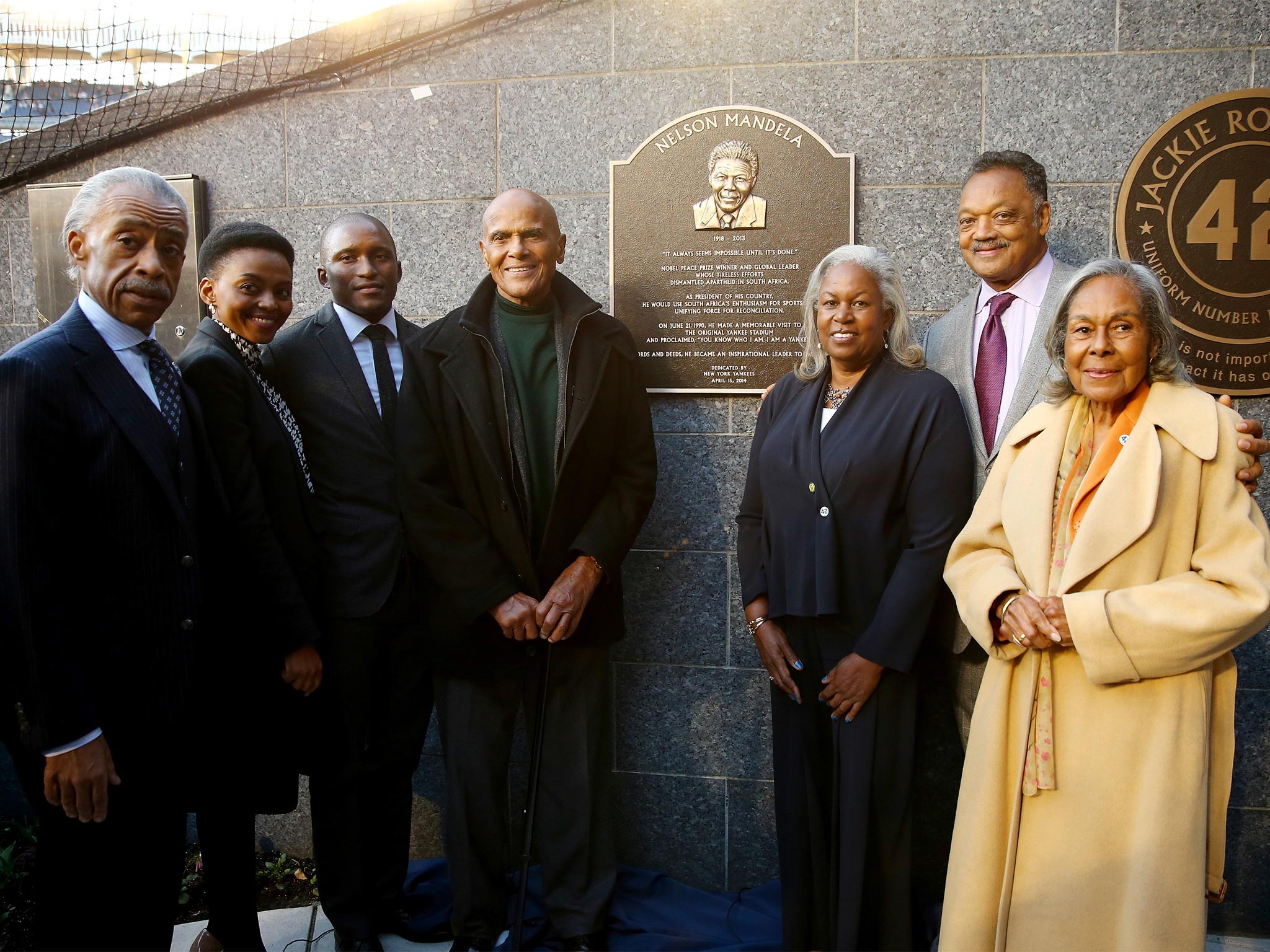 The Rev. Al Sharpton, Lindo Mandela, Zondwa Mandela, Harry Belafonte, Sharon Robinson, the Rev Jesse Jackson and Rachel Robinson, wife of the late baseball great Jackie Robinson, pose with a plaque memorializing the late South African President Nelson Man
