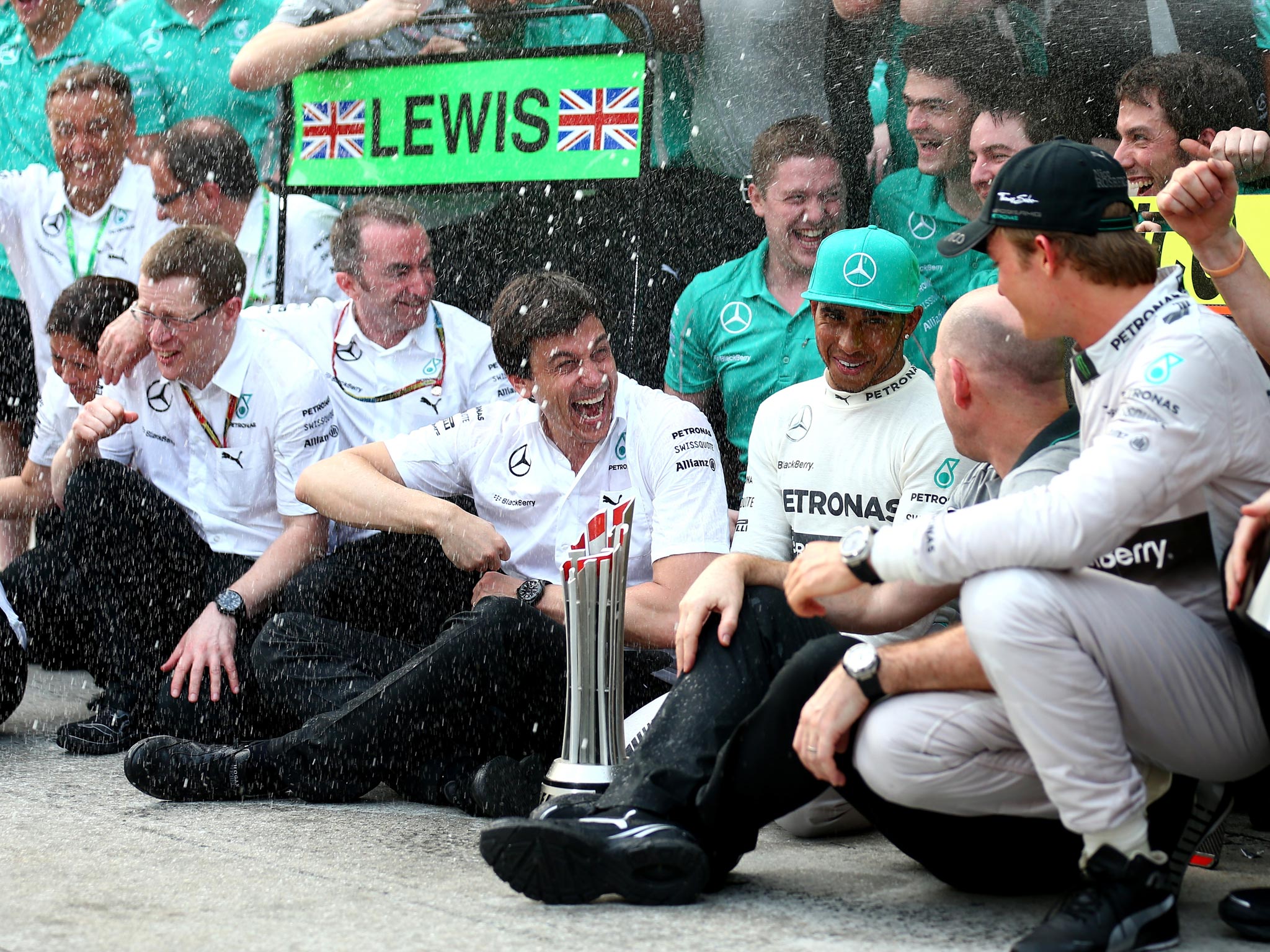 Toto Wolff celebrates with Lewis Hamilton, Nico Rosberg and the rest of the Mercedes team after the 0ne-two finish in Bahrain