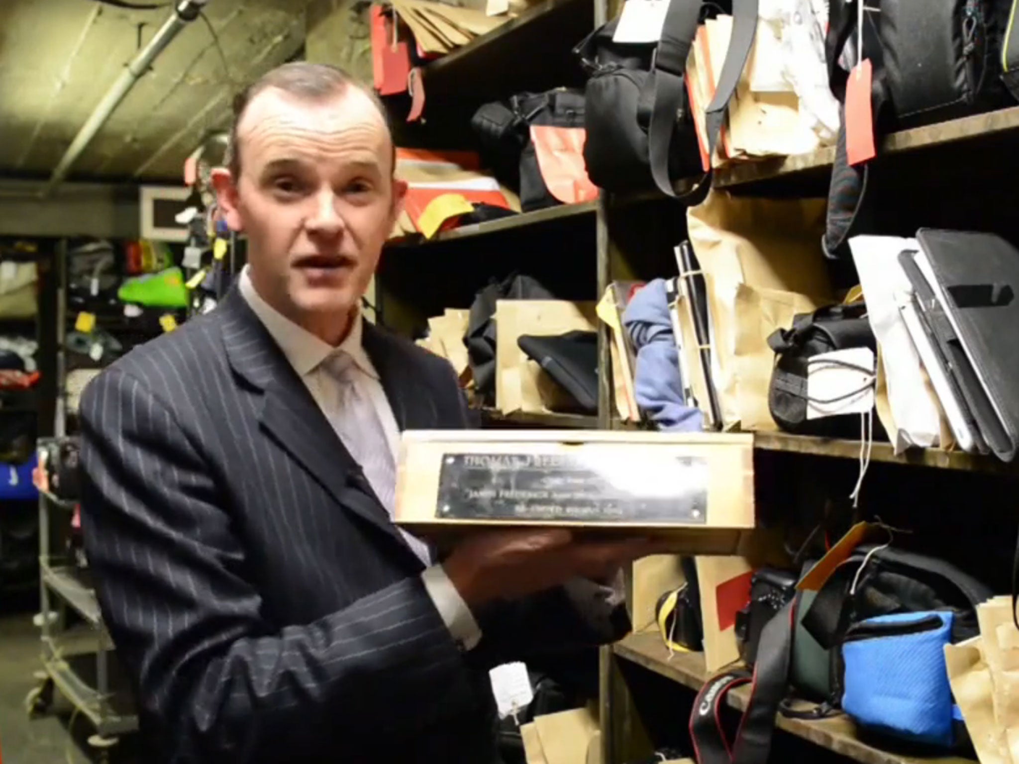 Paul Cowan holds up the box containing the ashes of Thomas Frederick Johnston
