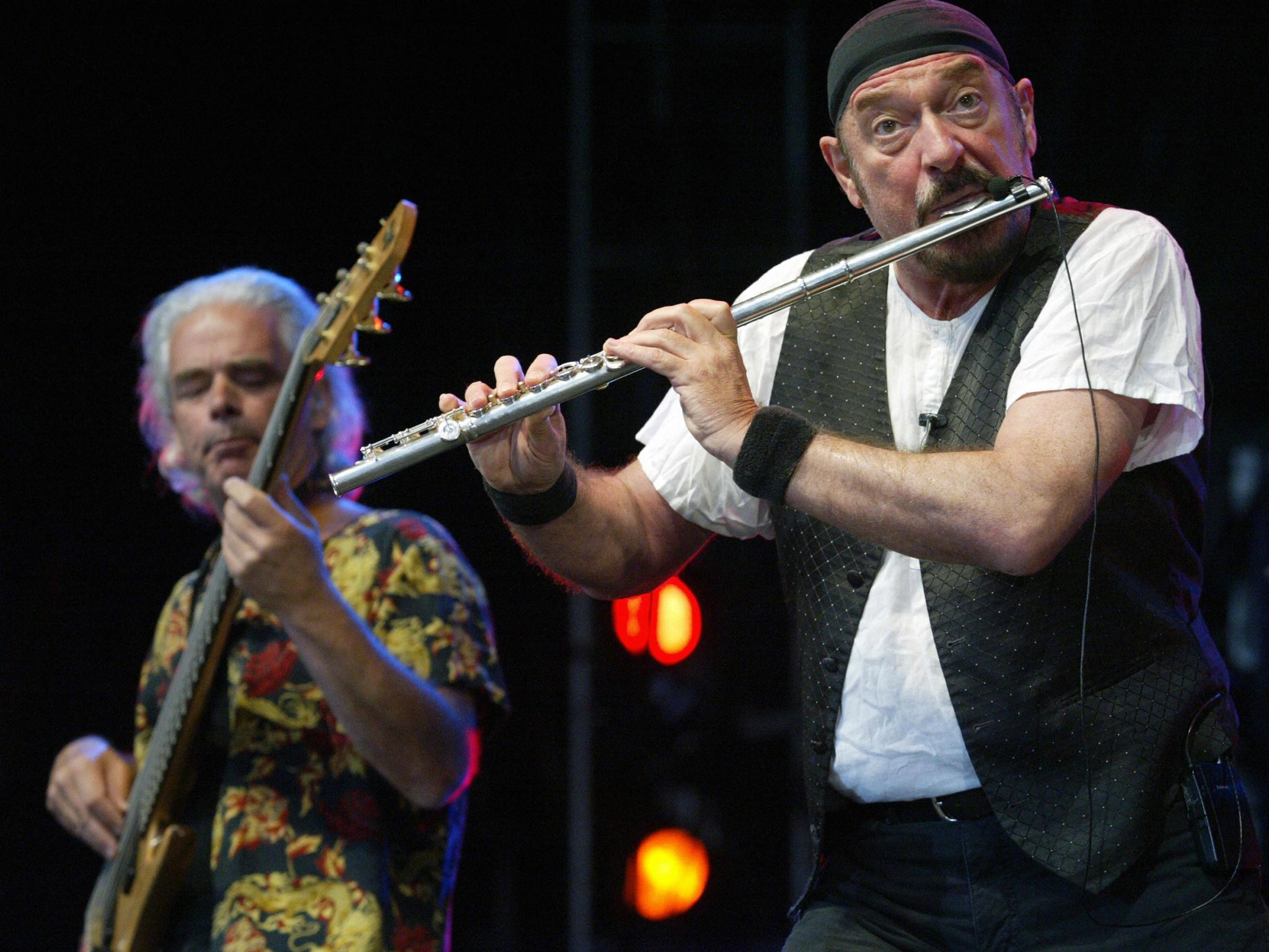 Ian Anderson, the leader of British rock band Jethro Tull, (right) and British guitar player Martin Barre (left) perform on stage