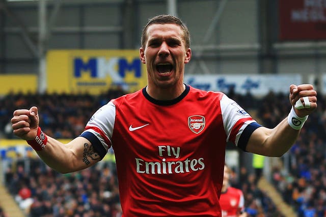 Lukas Podolski celebrates one of his two goals in Arsenal's win over Hull