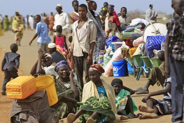South Sudanese fleeing an attack on the South Sudanese town of Rank, wait to register after arriving at a border gate in Joda, along the Sudanese border