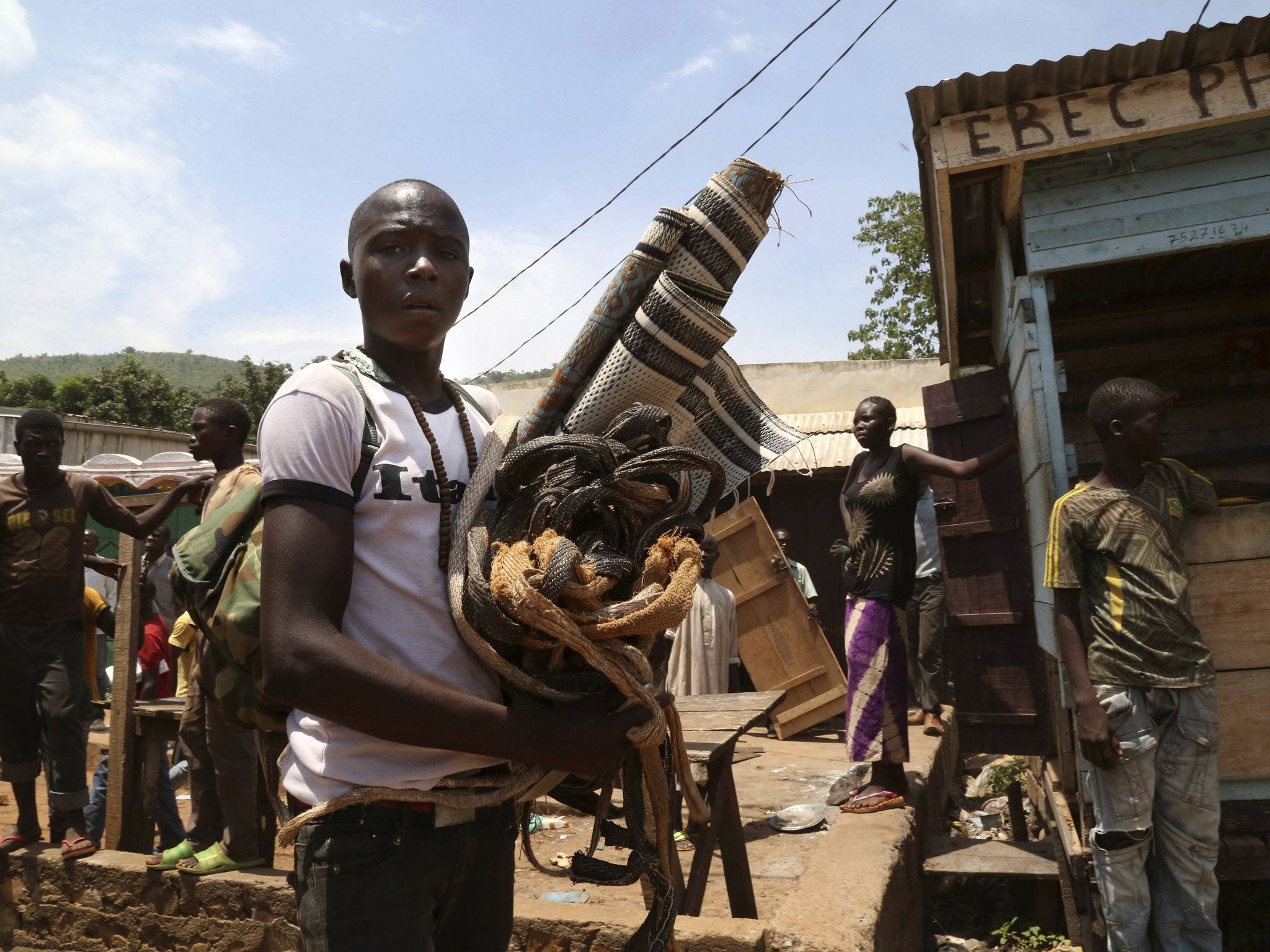 A Christian man carries property left behind by the Muslim community who were evacuated from the PK12 neighbourhood in Bangui. The relocation involves moving Muslims who have sheltered from sectarian violence for months in the PK12 neighbourhood, to the n