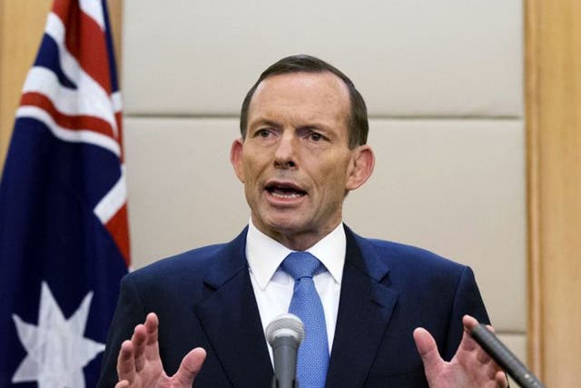 Australian Prime Minister Tony Abbott speaks during a press conference at a hotel in Beijing, China. Abbott said Monday, April 28 that the underwater hunt for the missing Malaysia Airlines jet will be expanded to include a massive swath of ocean floor tha