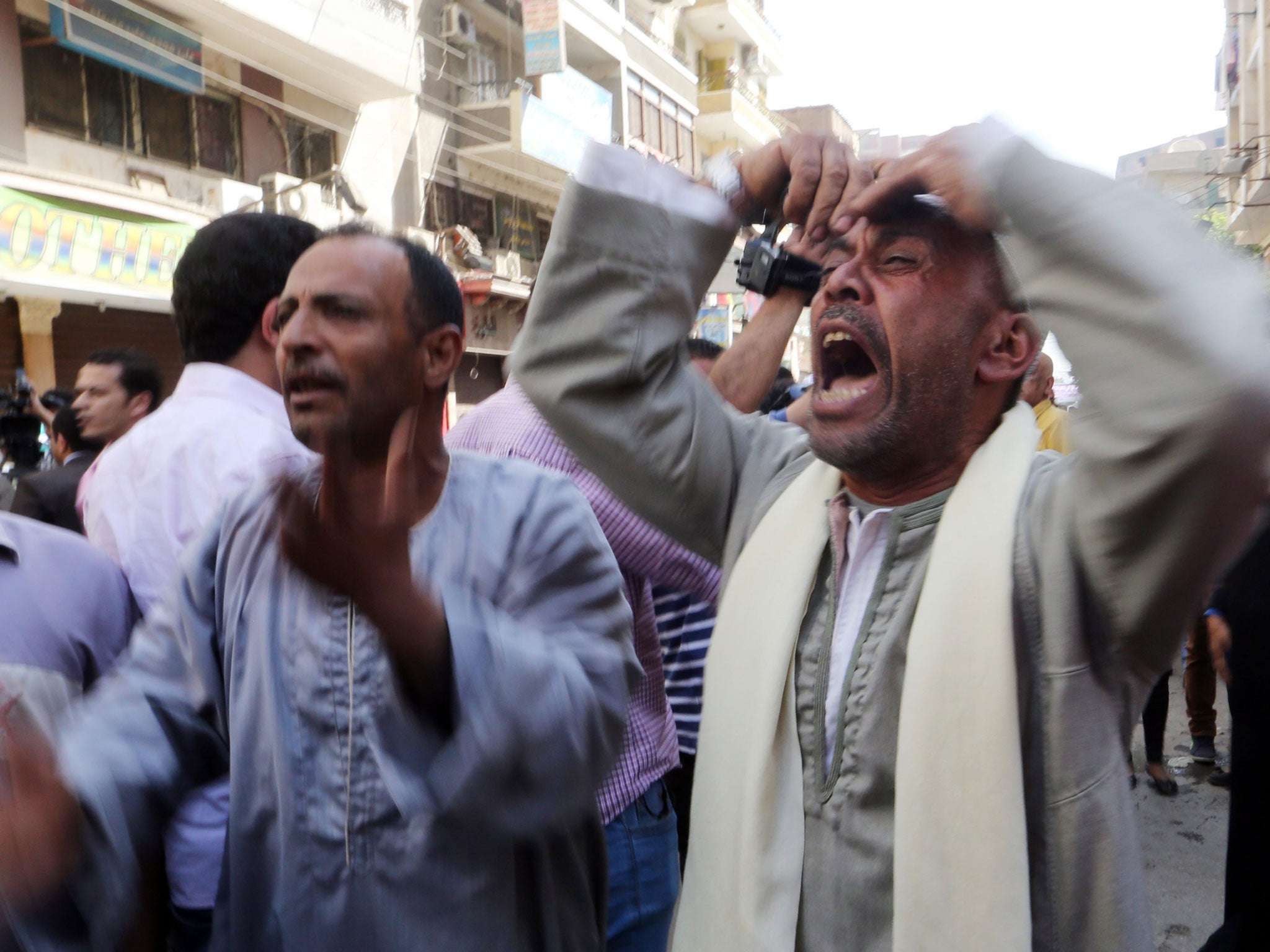 Egyptian relatives react outside a court during the trial of supporters of toppled president Mohamed Morsi in Minya