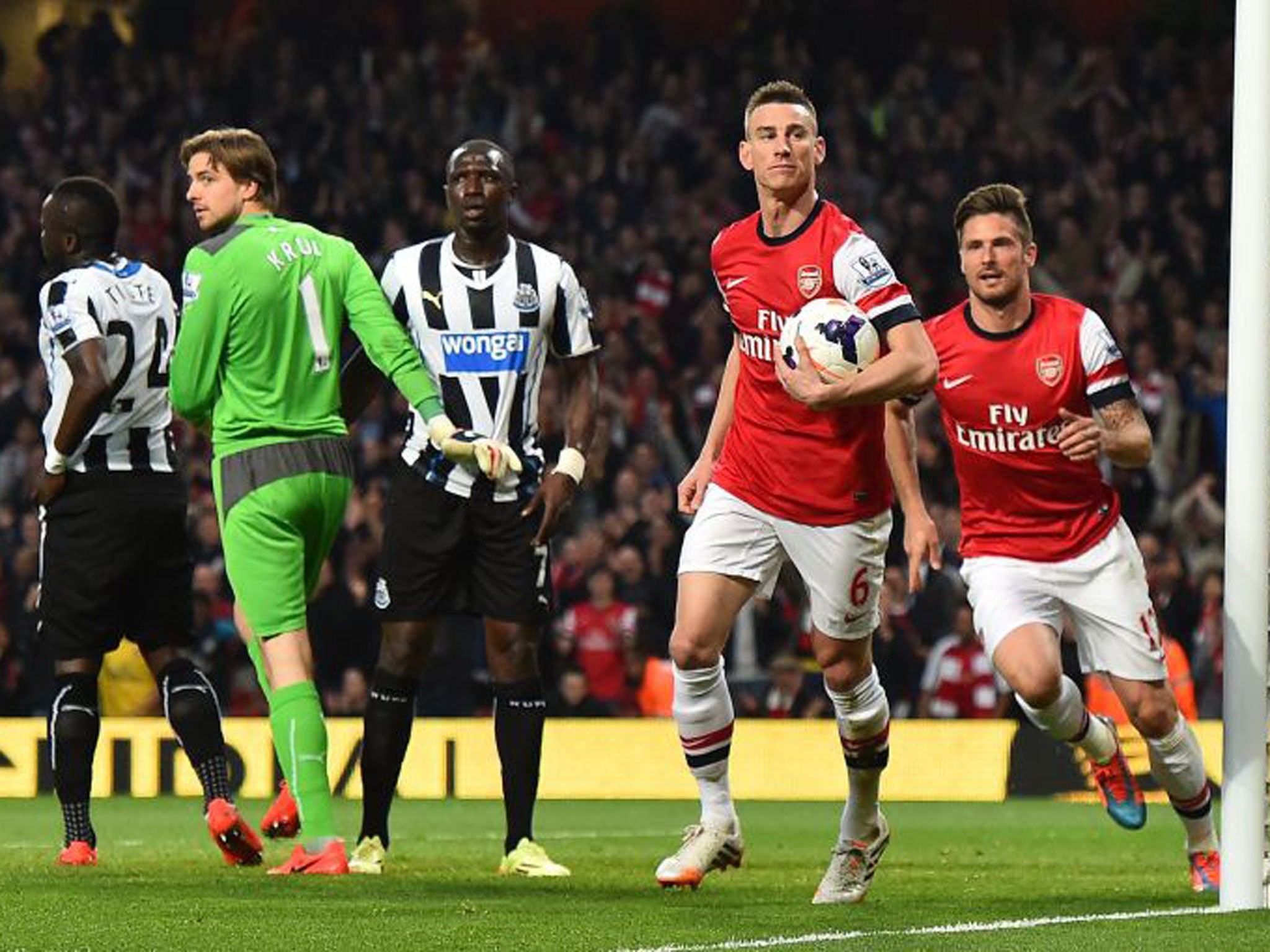 Arsenal’s French defender Laurent Koscielny (with ball) celebrates after opening the scoring the opener against Newcastle, when the Gunners won 3-0