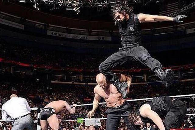 Seth Rollins of The Shield hits Triple H with a knee to the head