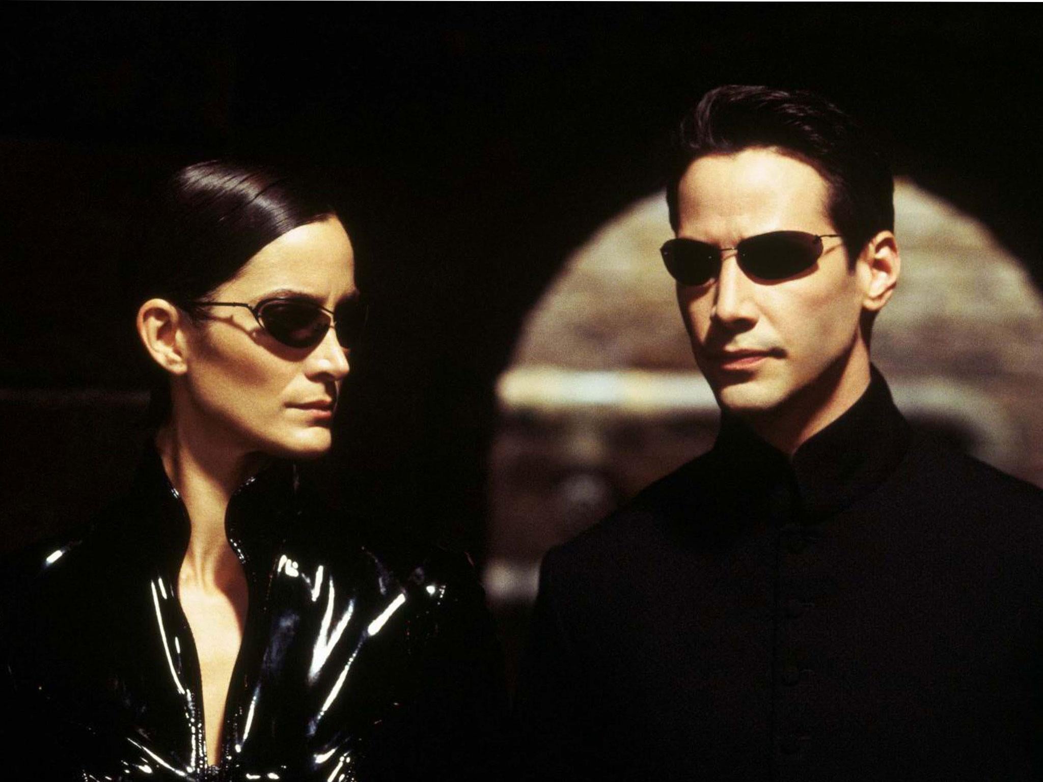 Carrie-Anne Moss as Trinity and Keanu Reeves as Neo in ‘The Matrix’