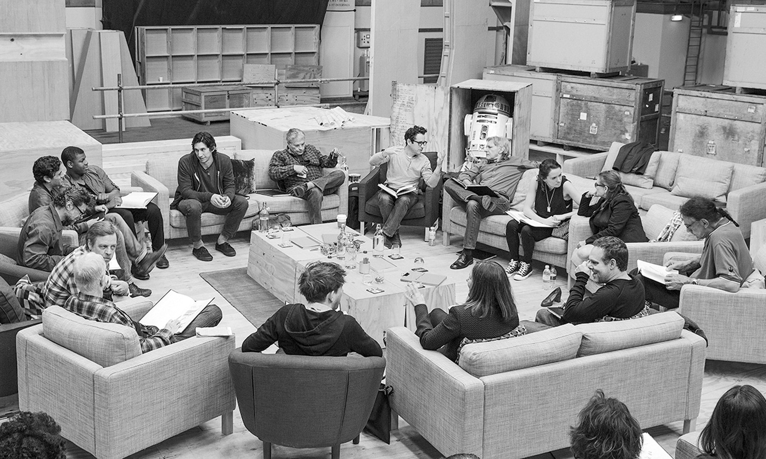 The Episode VII cast during a read-through at Pinewood Studios. (clockwise from top center right) Writer/Director/Producer J.J Abrams, Harrison Ford, Daisy Ridley, Carrie Fisher, Peter Mayhew, Producer Bryan Burk, Lucasfilm President and Producer Kathleen