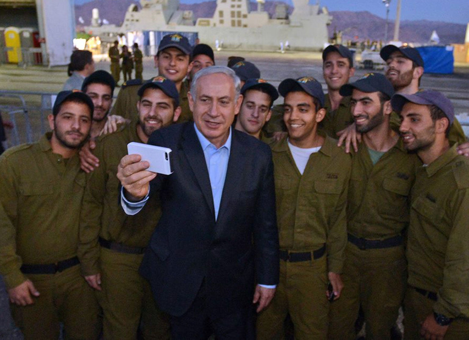 Israeli Prime Minister Benjamin Netanyahu takes a selfie with soldier at a military base