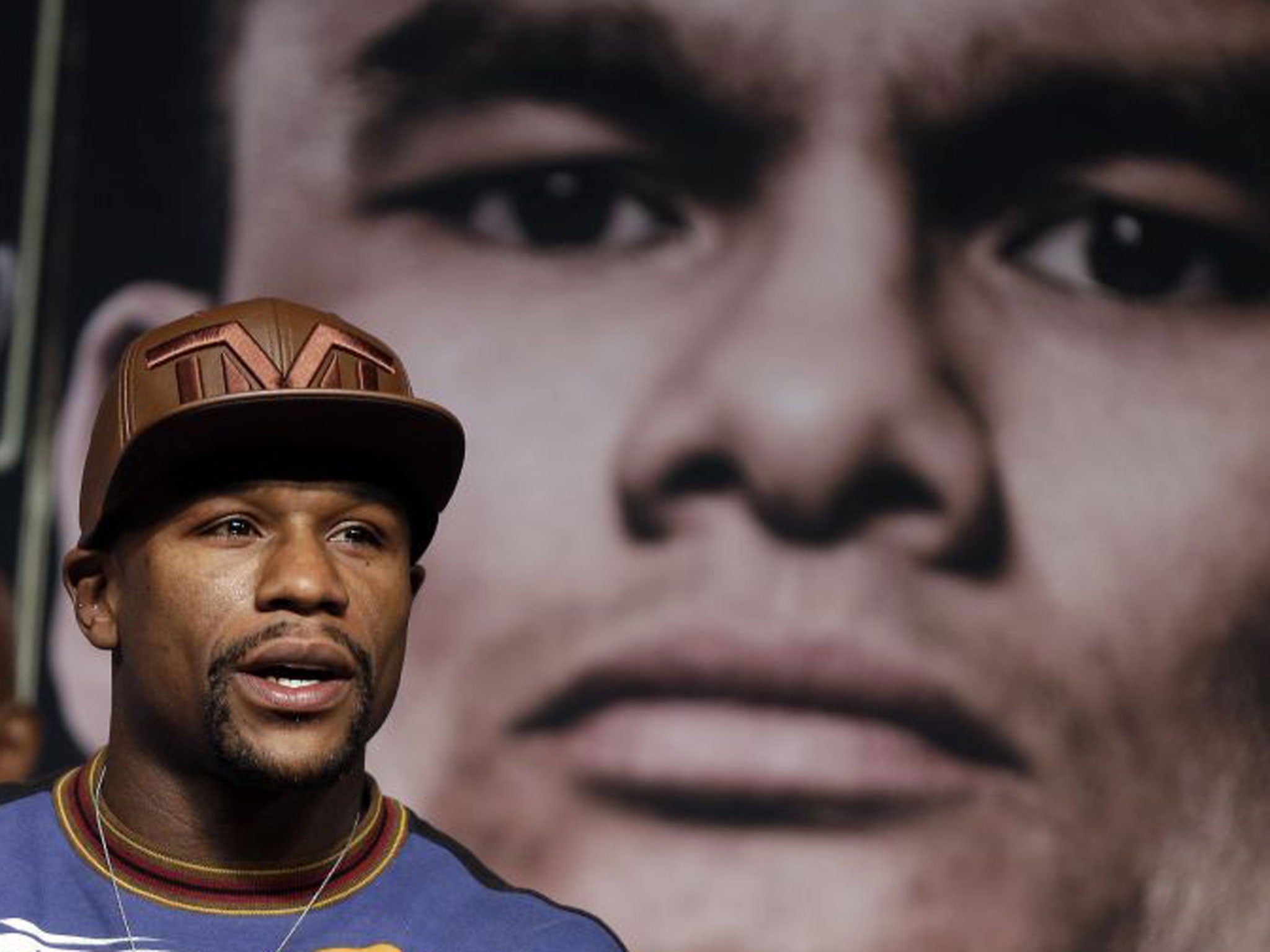 Floyd Mayweather (foreground) said that if Marcos Maidana (backdrop) planned to attack wildly, he would ‘get a beating’