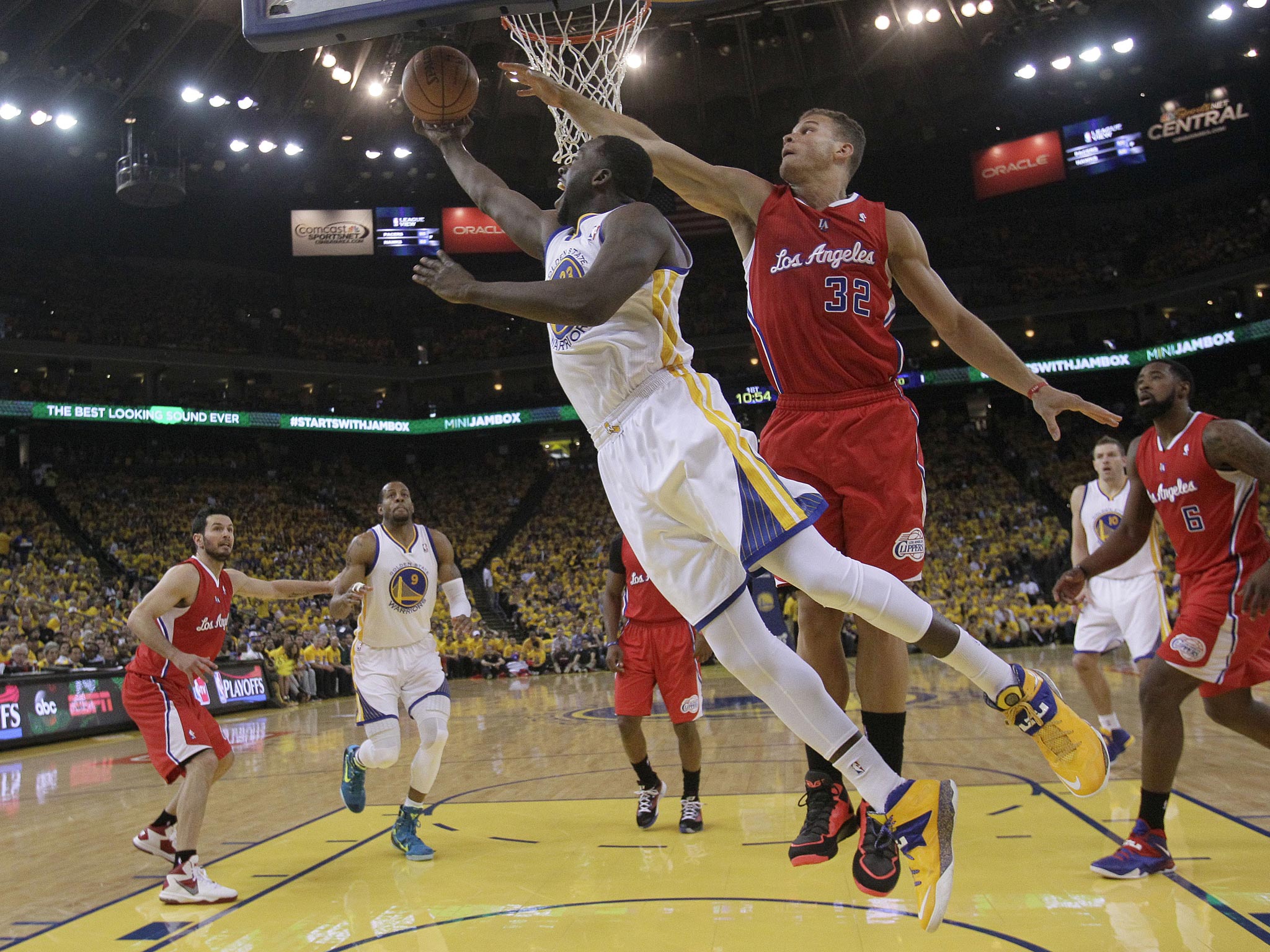 Golden State Warriors’ Draymond Green, front left, shoots against the LA Clippers on Thursday
