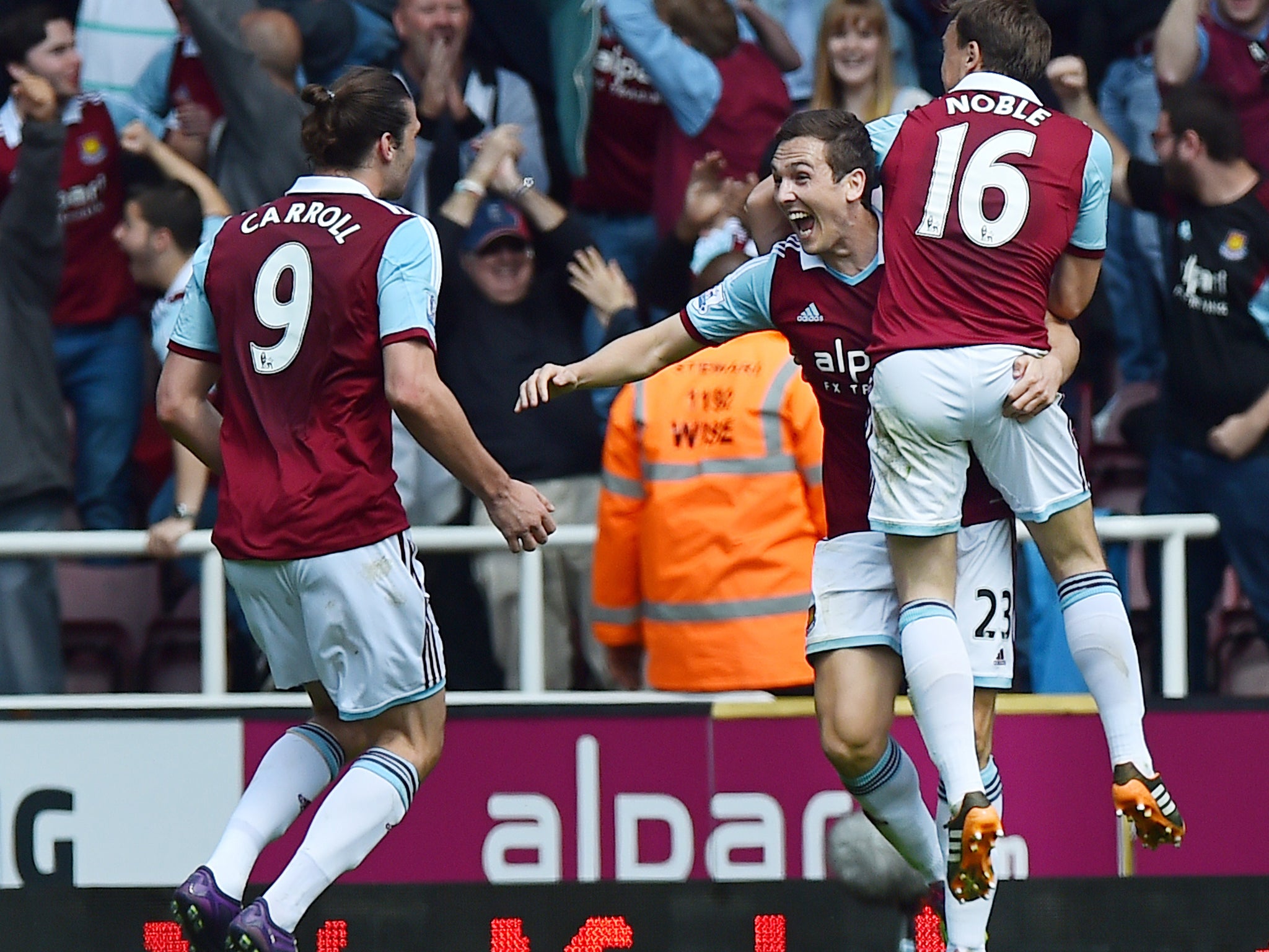 Stewart Downing celebrates with Andy Carroll and Mark Noble after scoring West Ham's second in the 2-0 win over Tottenham