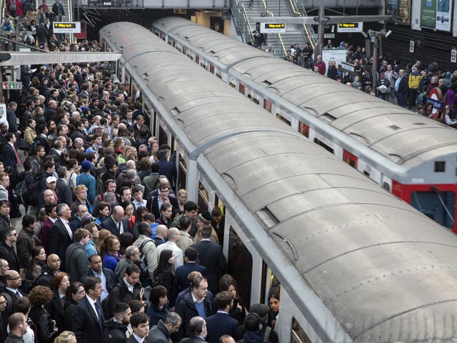 Commuters prepare to travel on the District Line of the London Underground during strike action on 30 April, 2014