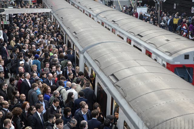 Commuters prepare to travel on the District Line of the London Underground during strike action on 30 April, 2014