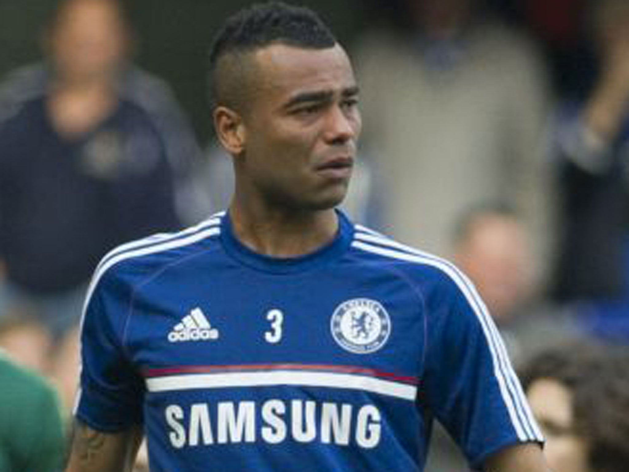 Ashley Cole looks devastated as he walks around the Stamford Bridge pitch on Sunday
