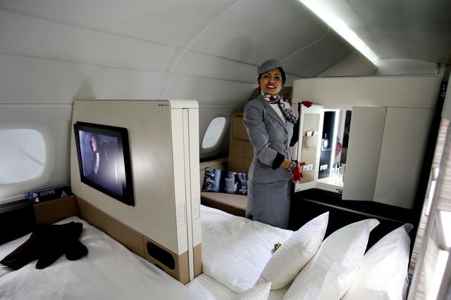 An Etihad Airways official stands inside a mock-up first class cabin,