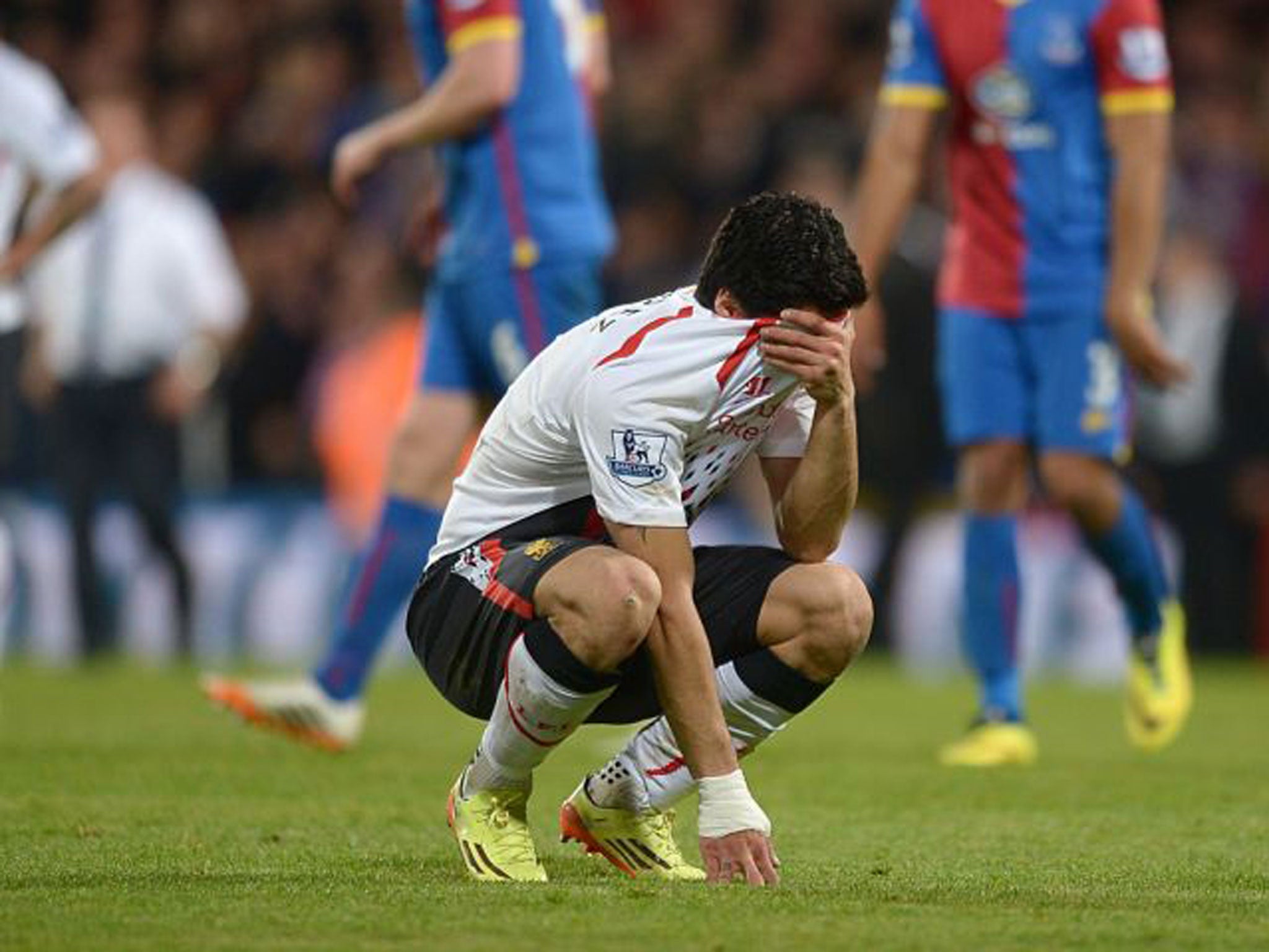 Liverpool striker Luis Suarez is distraught after drawing the match against Crystal Palace where the Uruguayan had equalled the record number of goals in a Premier League season