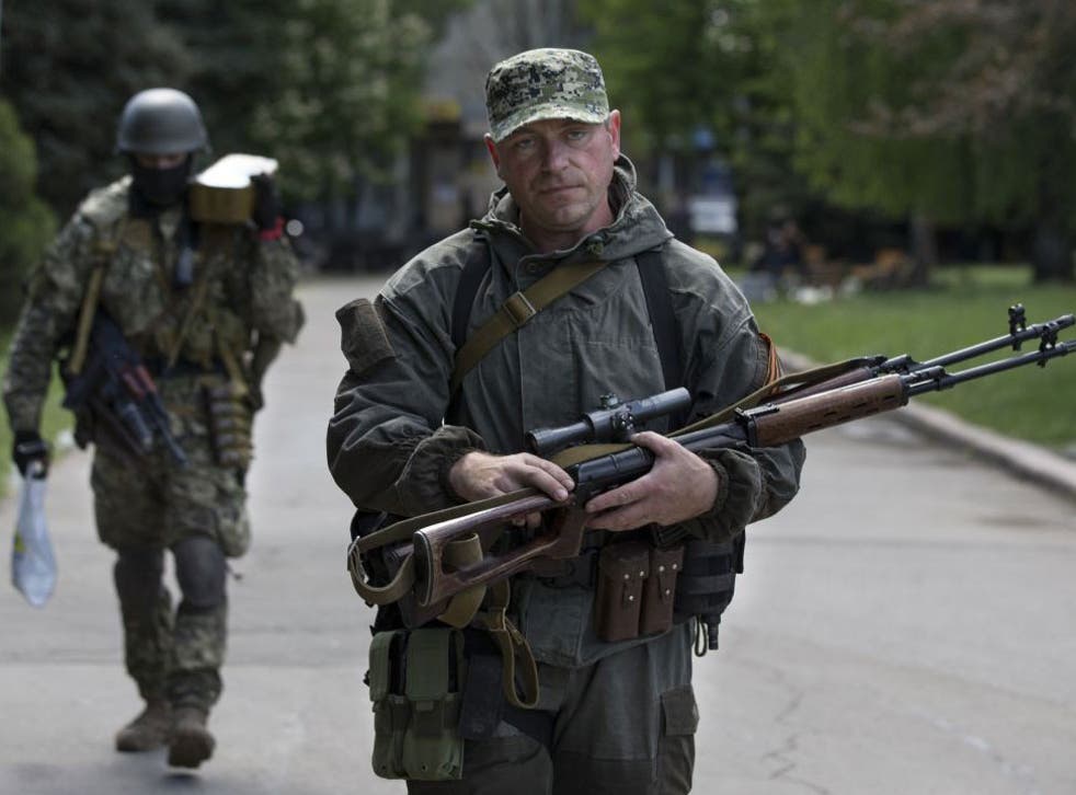 Pro-Russian gunmen carry their weapons at the local administration building in the centre of Slovyansk, Ukraine, on 6 May.