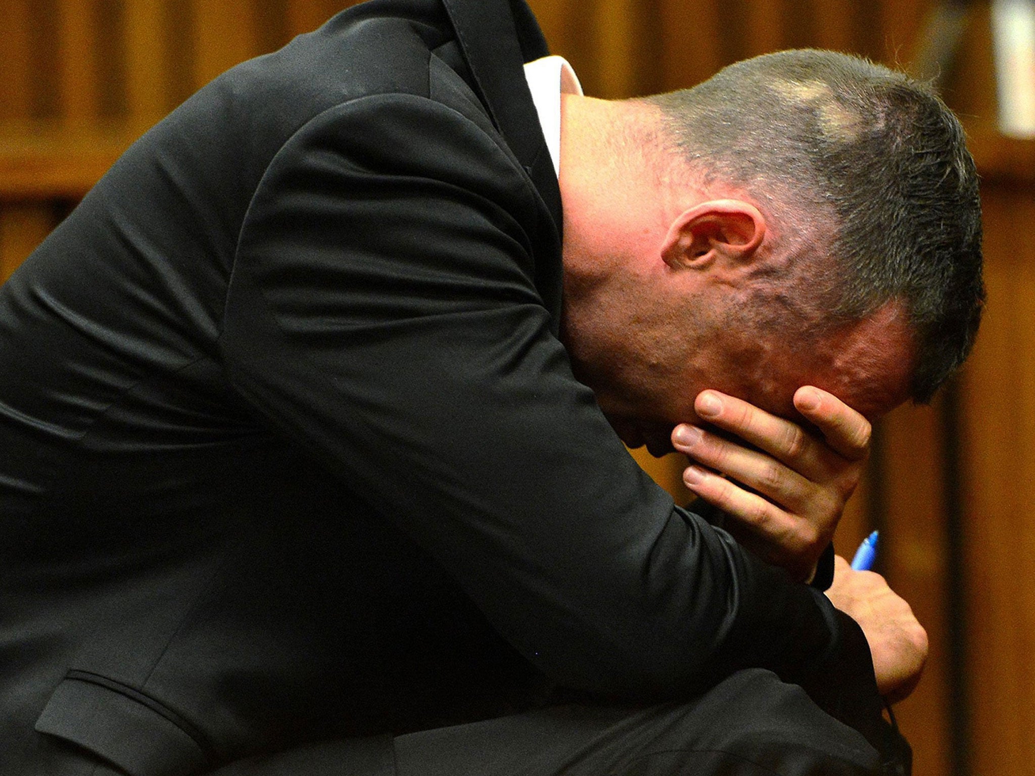 Oscar Pistorius reacts in the dock at the high court in Pretoria